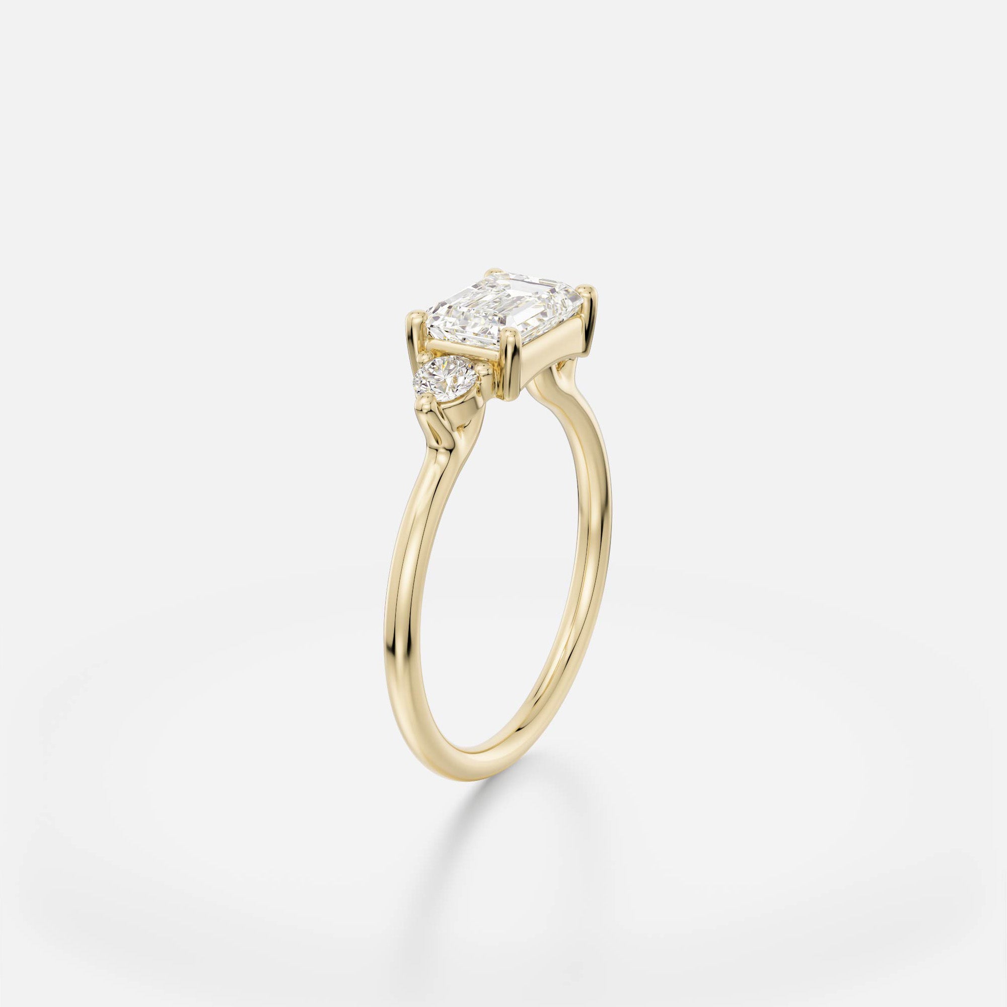 Kala east west emerald diamond cluster engagement ring angled side view