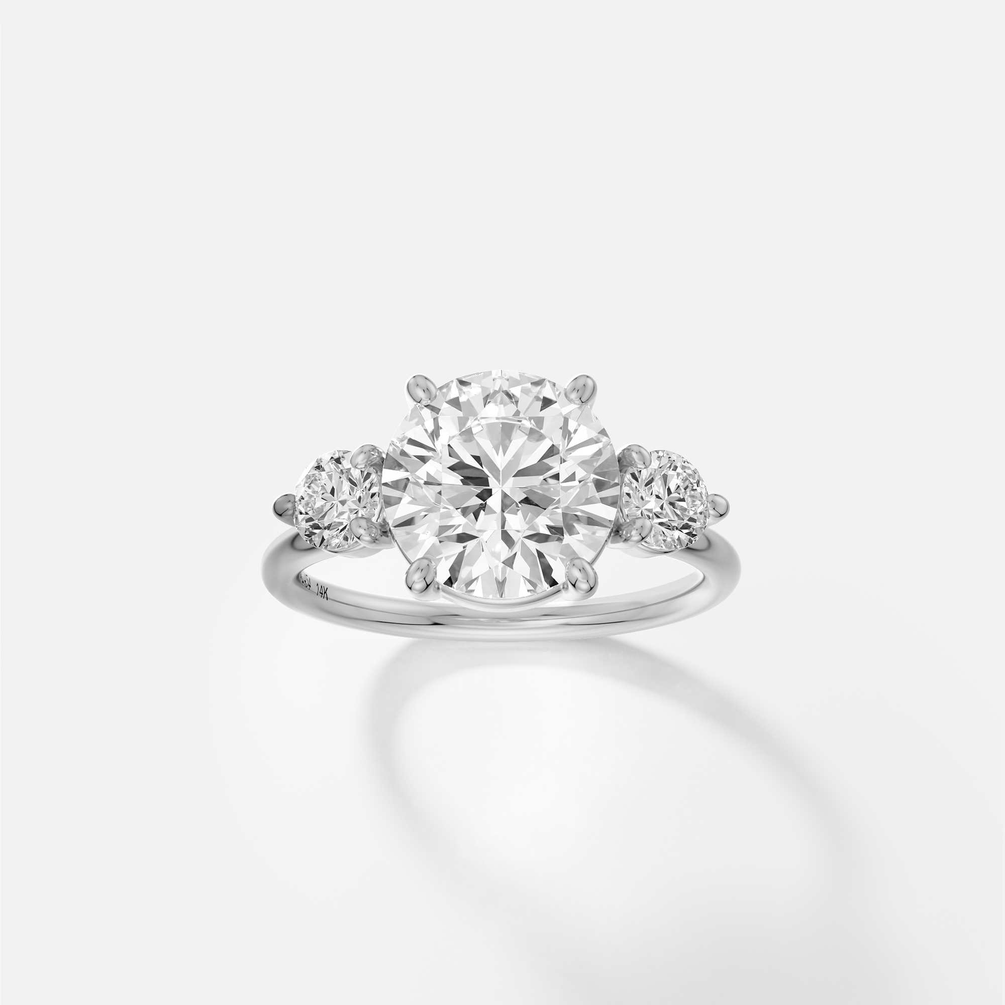 Kala round diamond three stone engagement ring front view in platinum