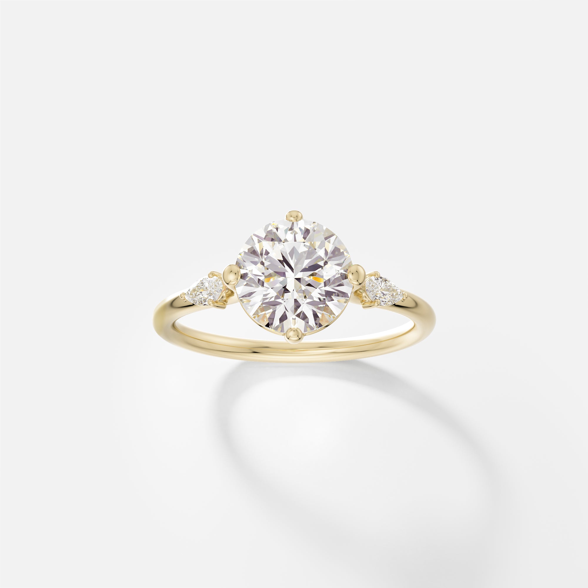 Three Stone Veli round diamond engagement ring with pear side stones front view