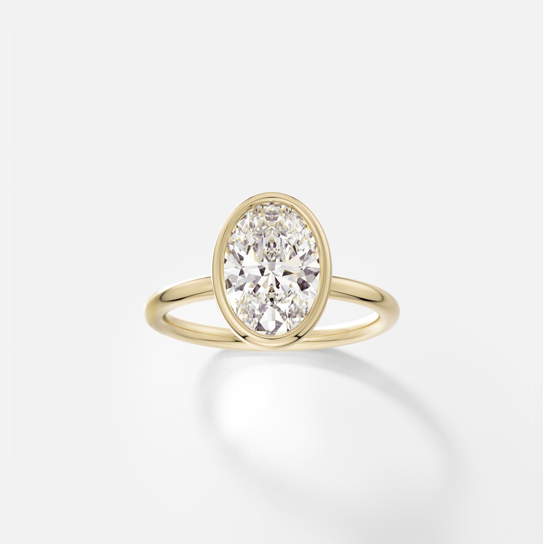 14k yellow gold engagement ring with 2.00 carat oval diamond set north south in thin bezel on delicate round band