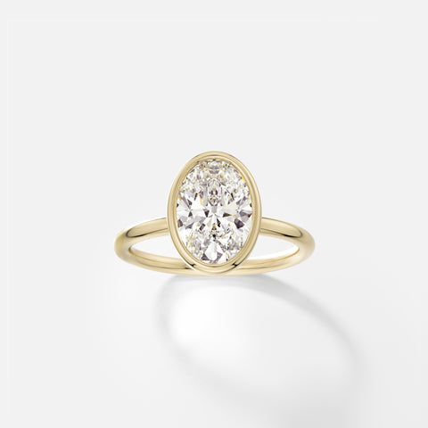 14k yellow gold engagement ring with 2.00 carat oval diamond set north south in thin bezel on delicate round band