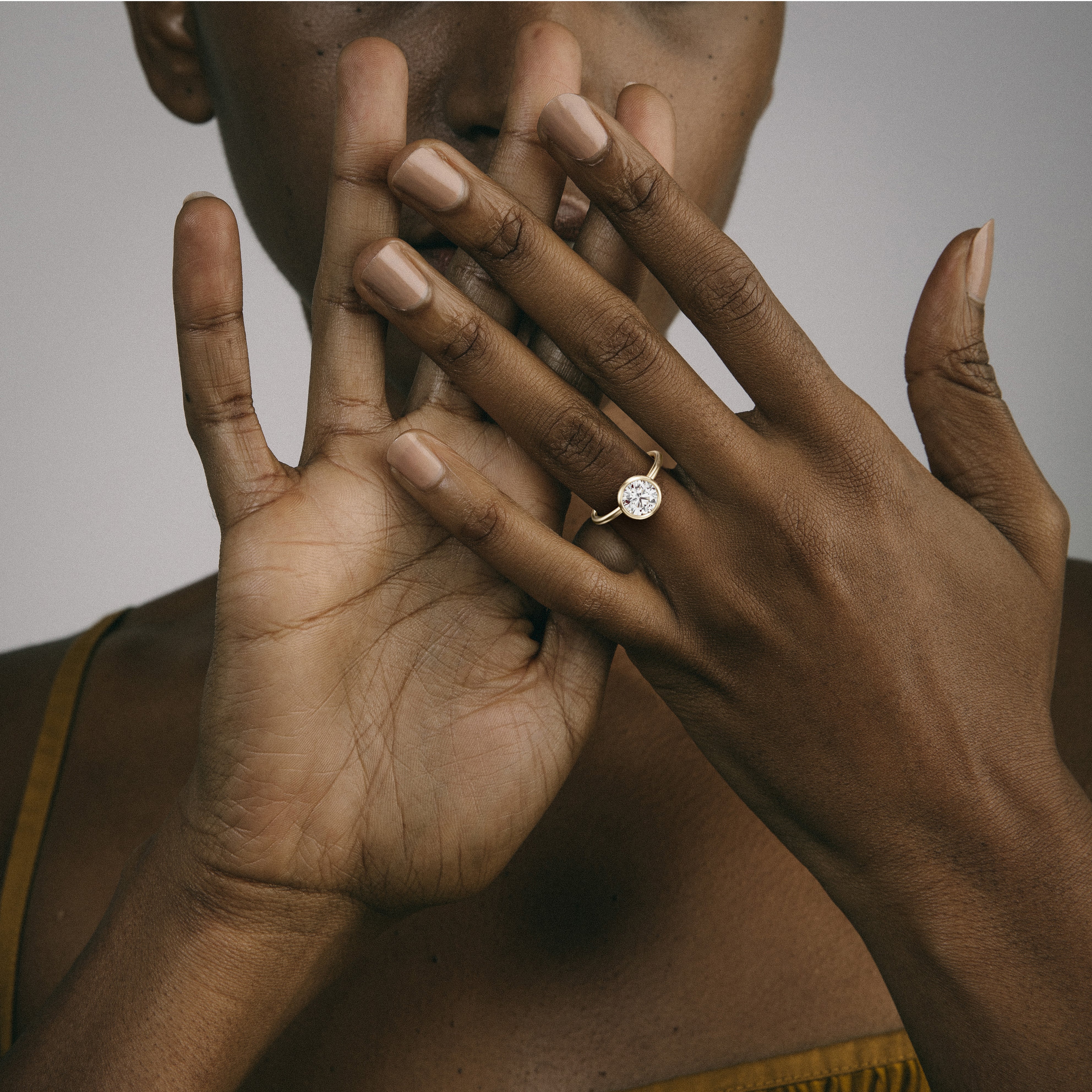 14k yellow gold engagement ring with 1.75 carat round diamond worn on hand