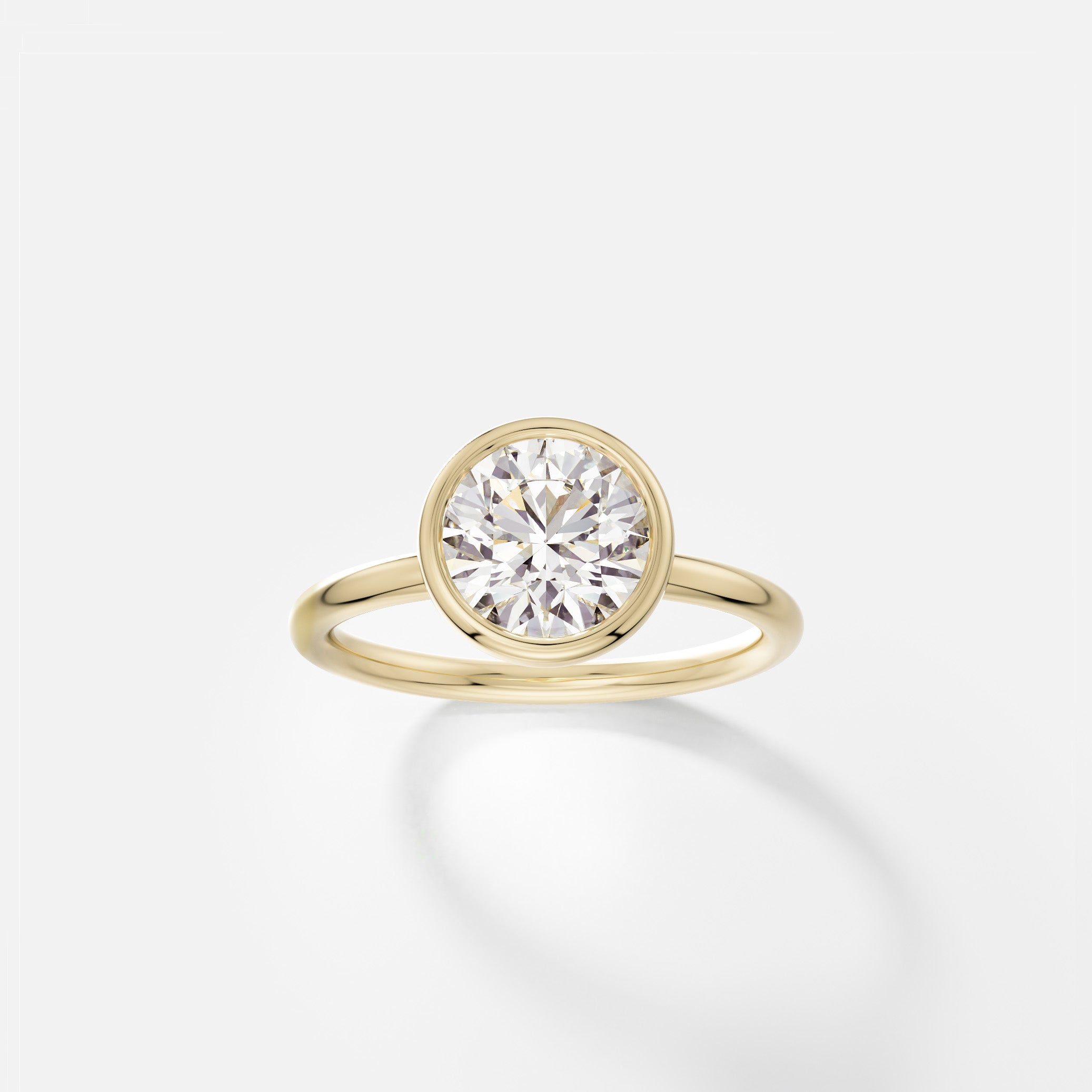 Arti round diamond bezel engagement ring front view in 14k yellow gold
