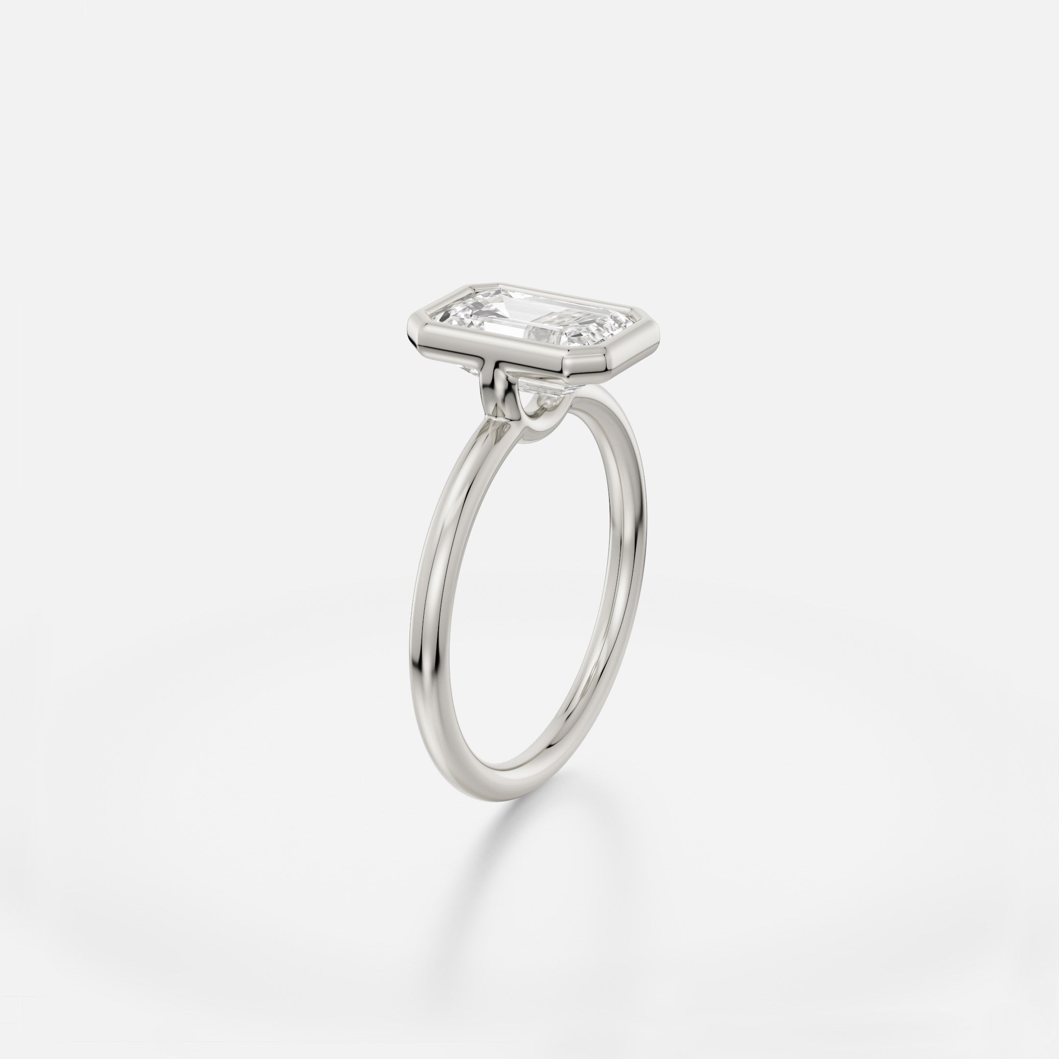 Platinum engagement ring with slim round band and 2 ct round diamond in minimalist bezel