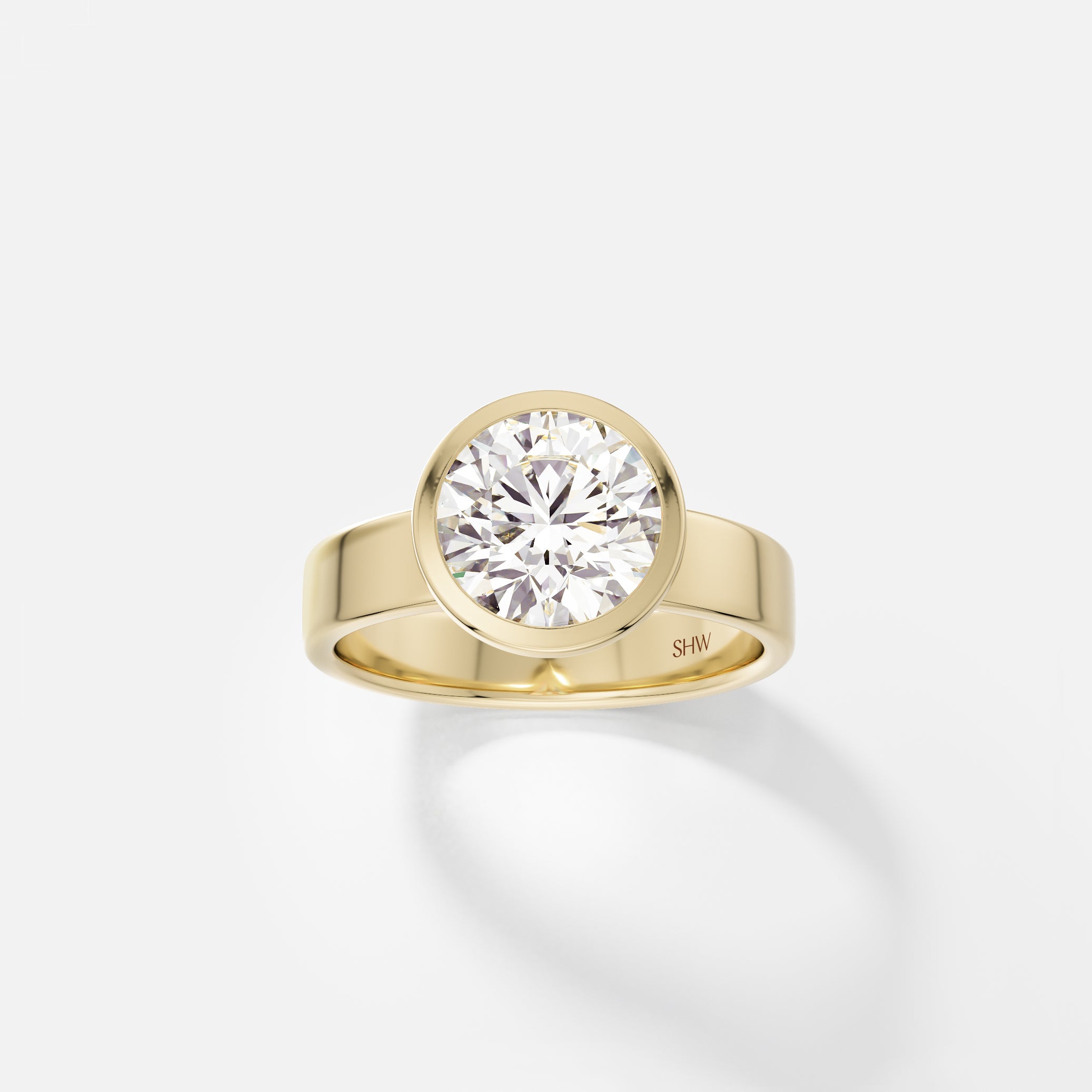 14k yellow gold wide flat band engagement ring with 2.25 carat round diamond in thin bezel setting