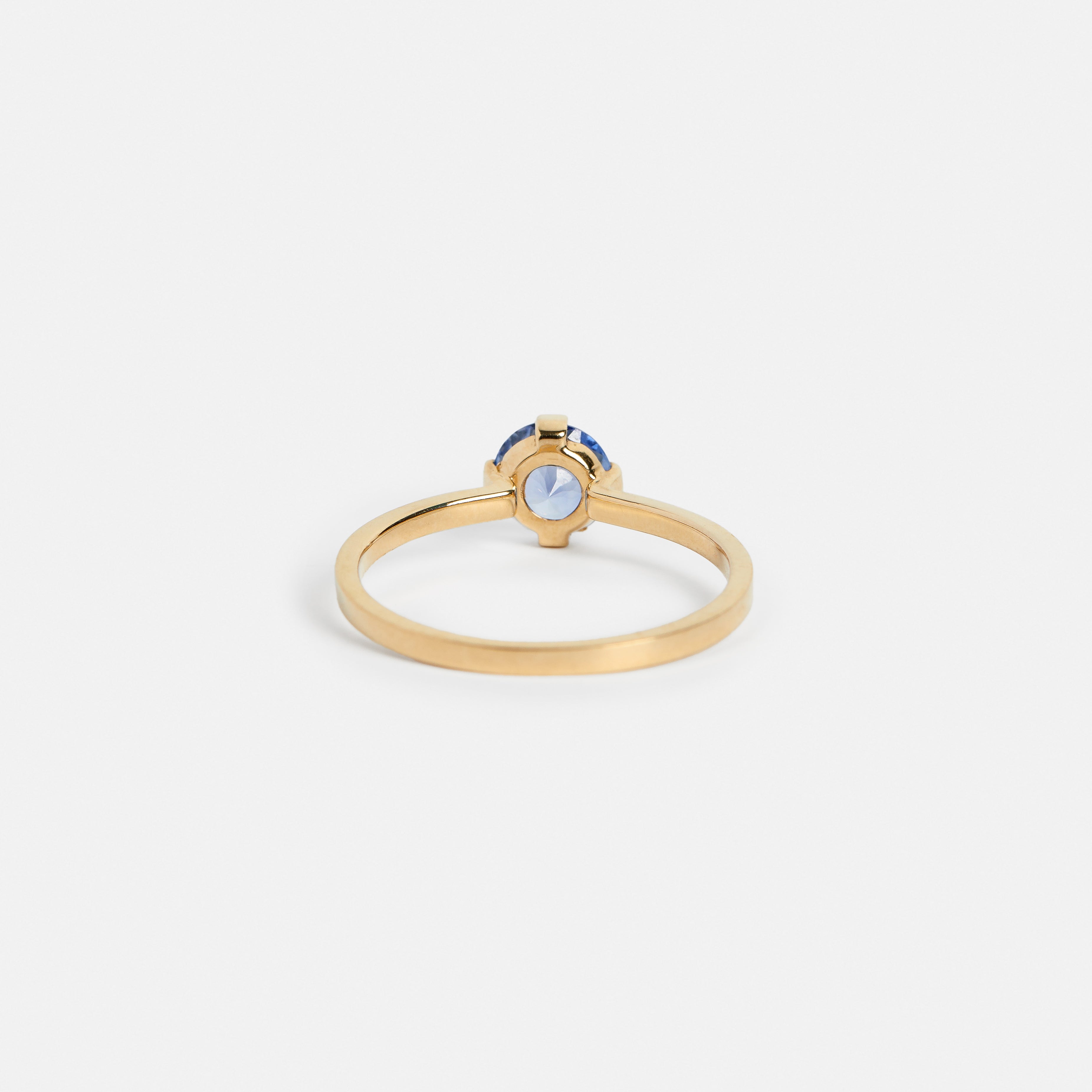 Simple Delicate Claws engagement ring with under 1ct montana blue sapphire in 14k yellow gold by SHW cool jewelry stores in NYC SoHo