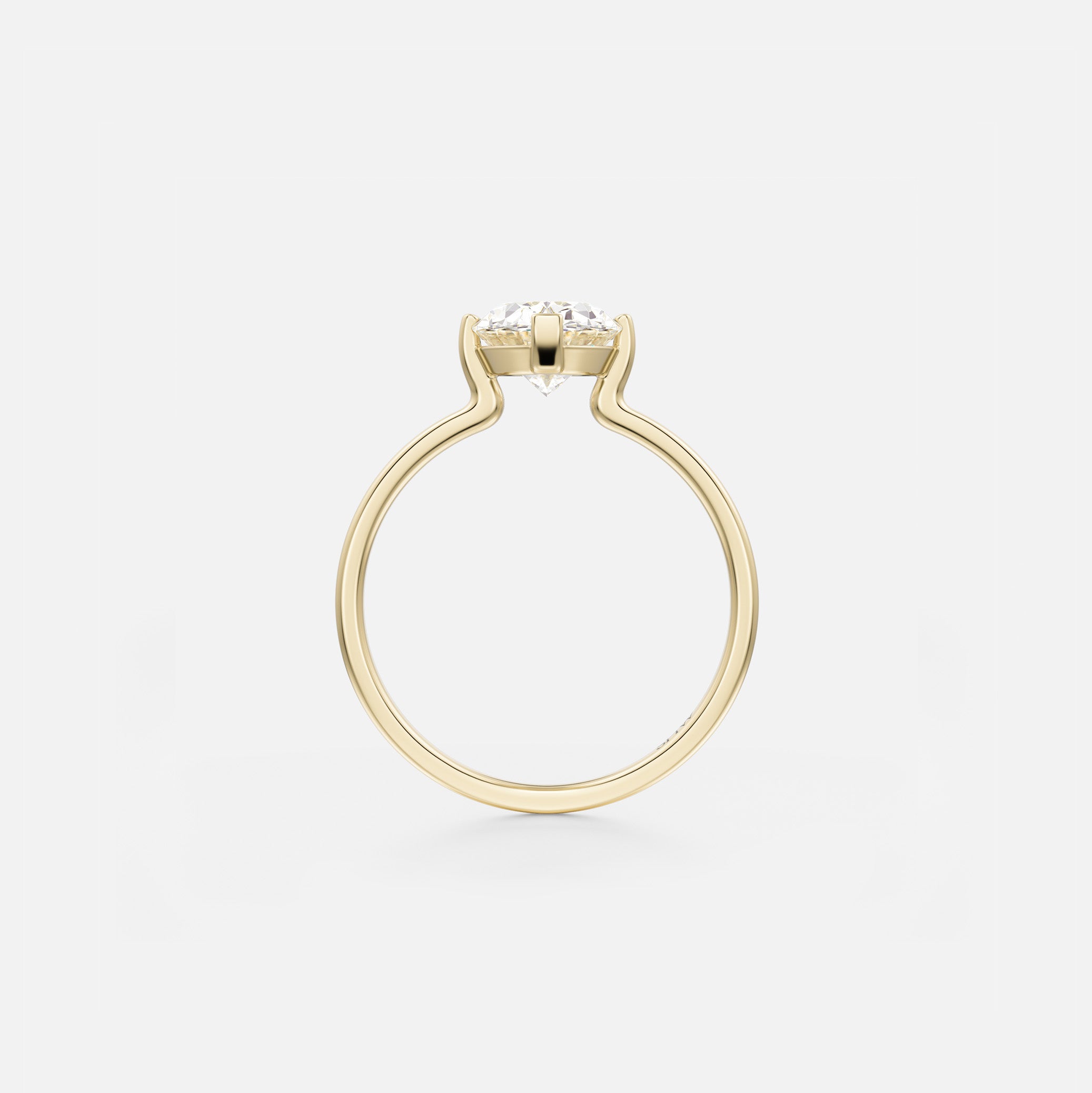 Thin flat gold band with open side setting and compass prongs holding oval diamond