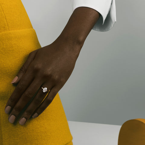 Close view of 1.71 ct oval diamond on slim flat profile band