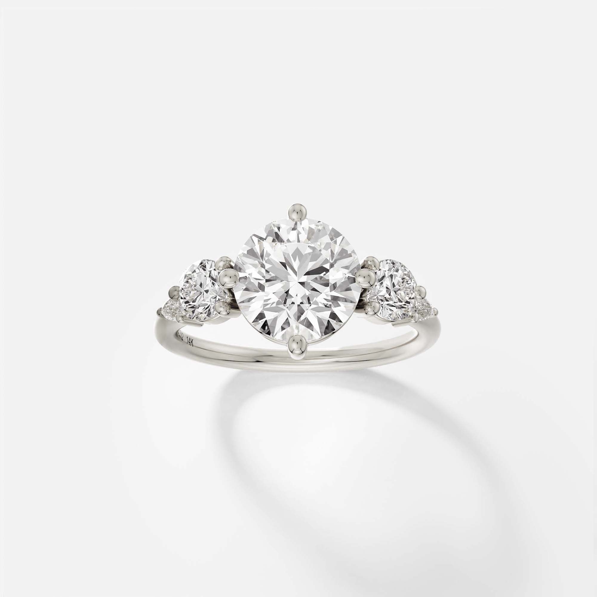 14k white gold five stone engagement ring with 2.50 ct round brilliant diamond and pear and round accent stones