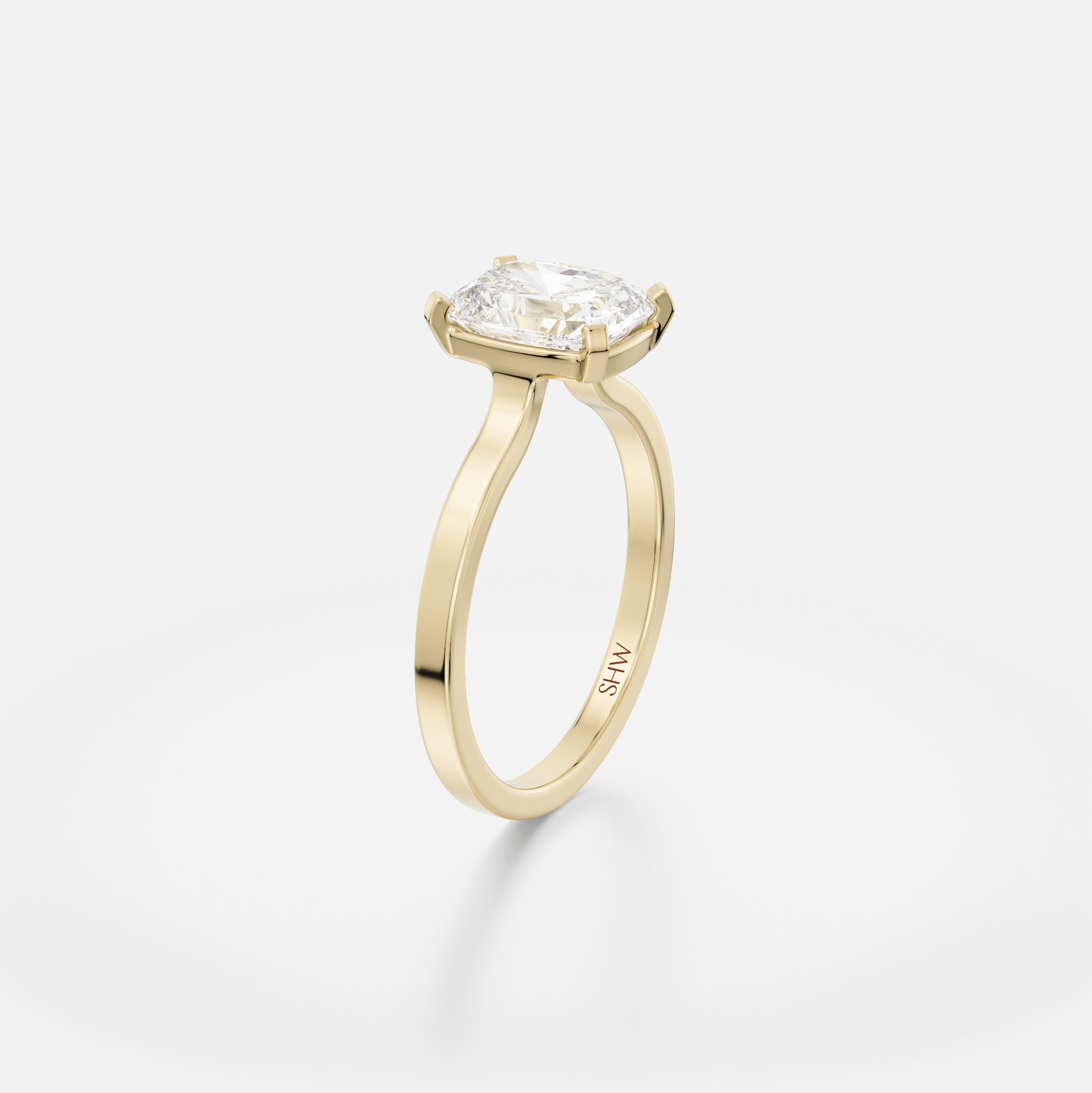 Delicate flat profile engagement ring with open setting holding 1.5 ct cushion-cut diamond