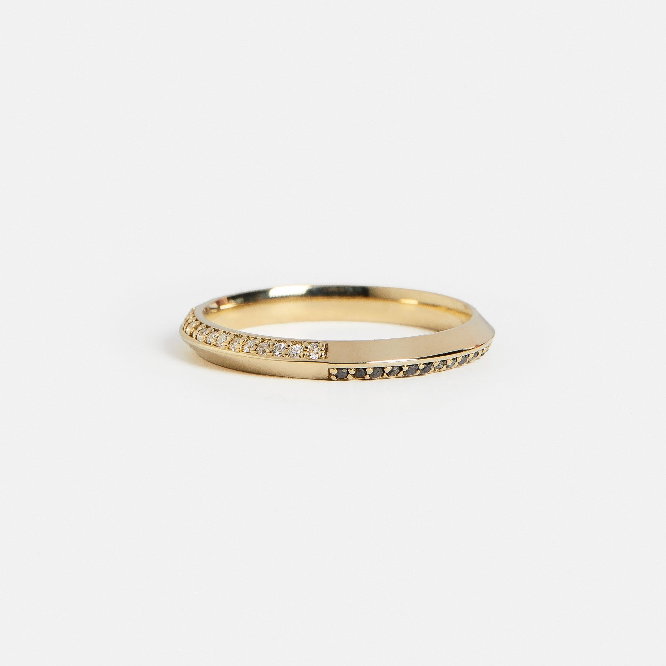 14k yellow gold band with white diamond pavé on one side and black diamond pavé on the other