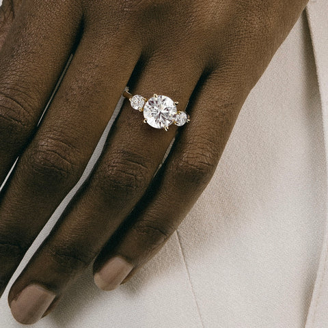 Kala 2.50 carat round diamond three stone ring close hand detail