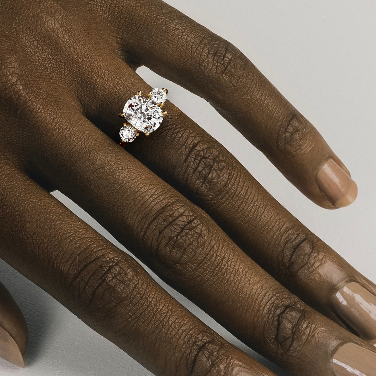 Kala 3.25 carat elongated cushion diamond three stone ring close hand detail