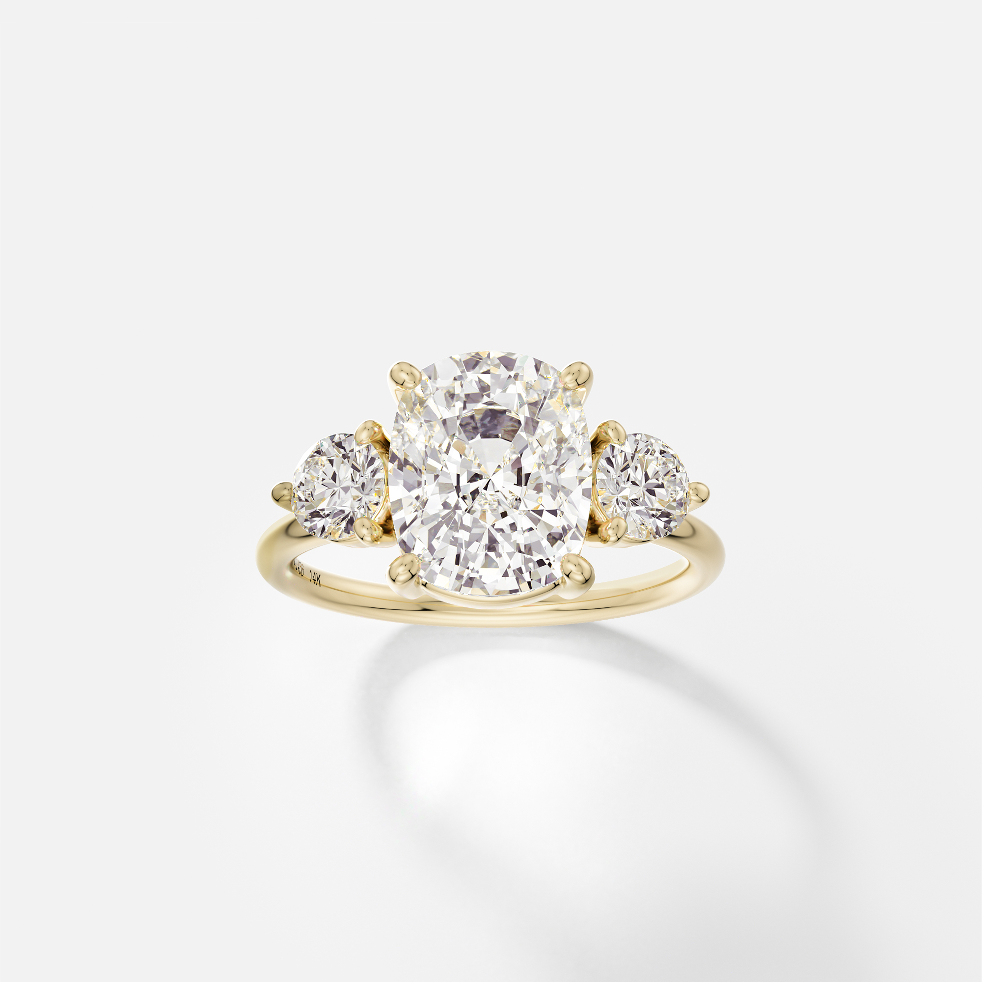 Kala elongated cushion diamond three stone engagement ring with round side stones front view in 14k yellow gold