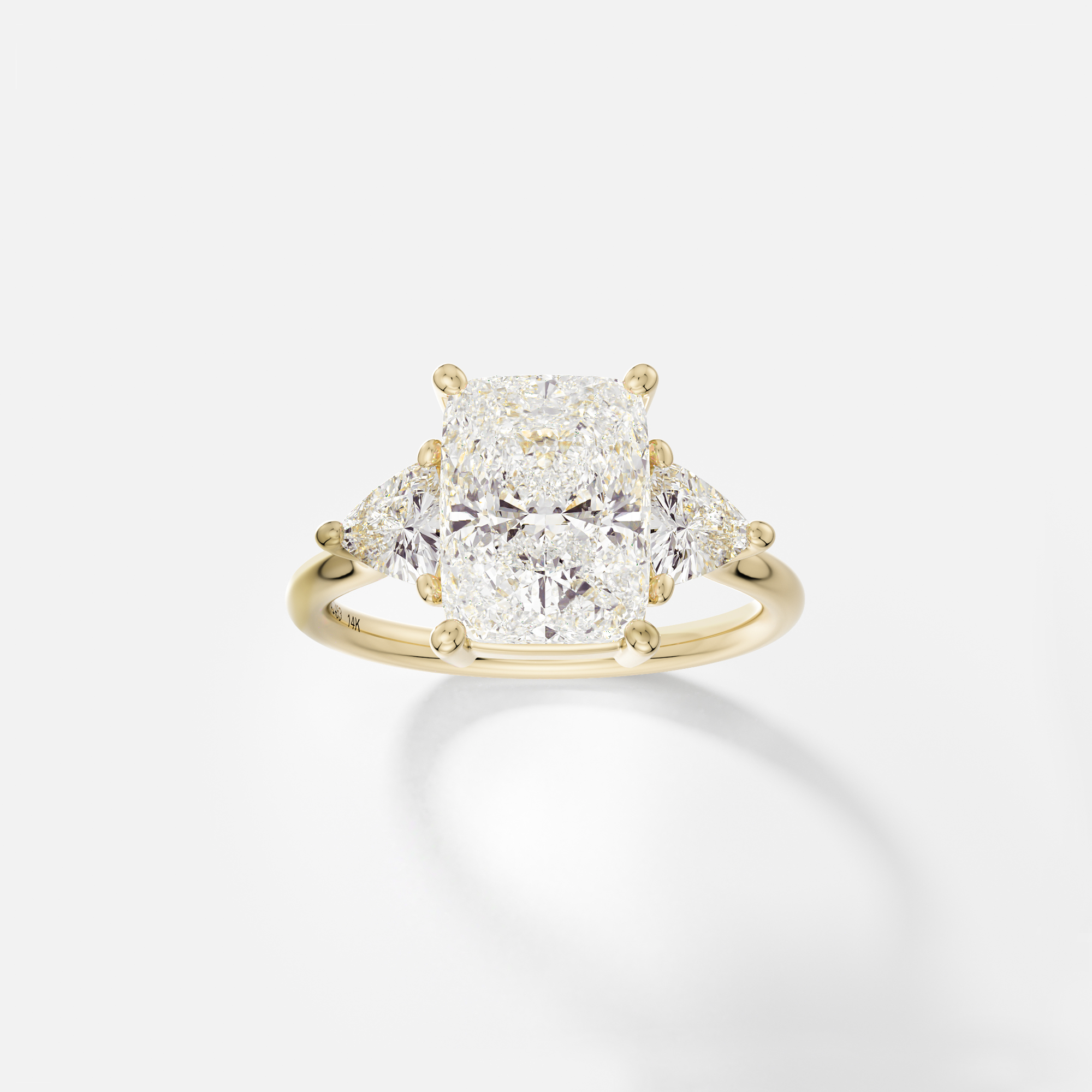 14k yellow gold three stone engagement ring with 3.00 carat elongated cushion diamond and trillion-cut side stones in corner prong setting