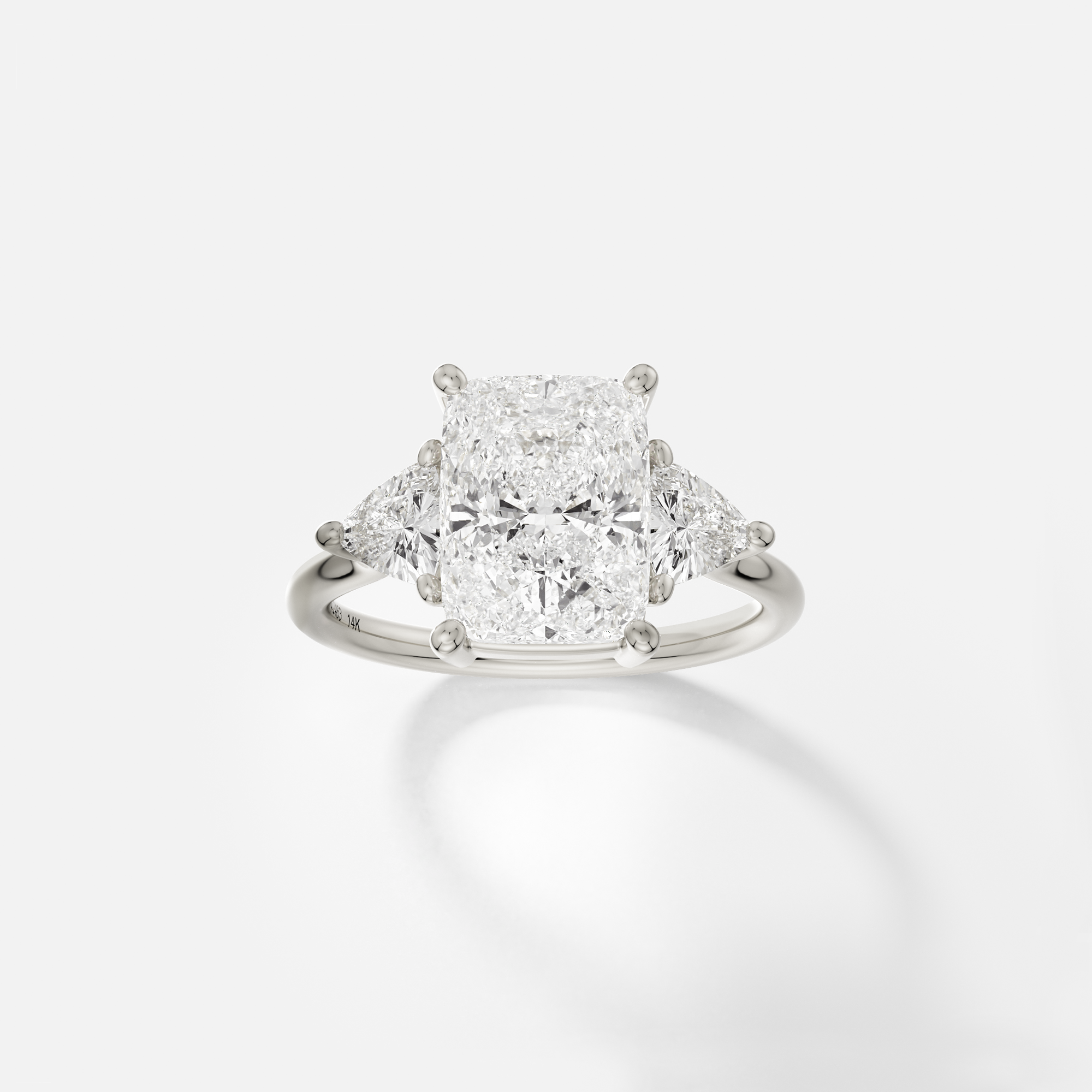 14k white gold engagement ring with 3.00 ct elongated cushion diamond and trillion side stones in prong setting