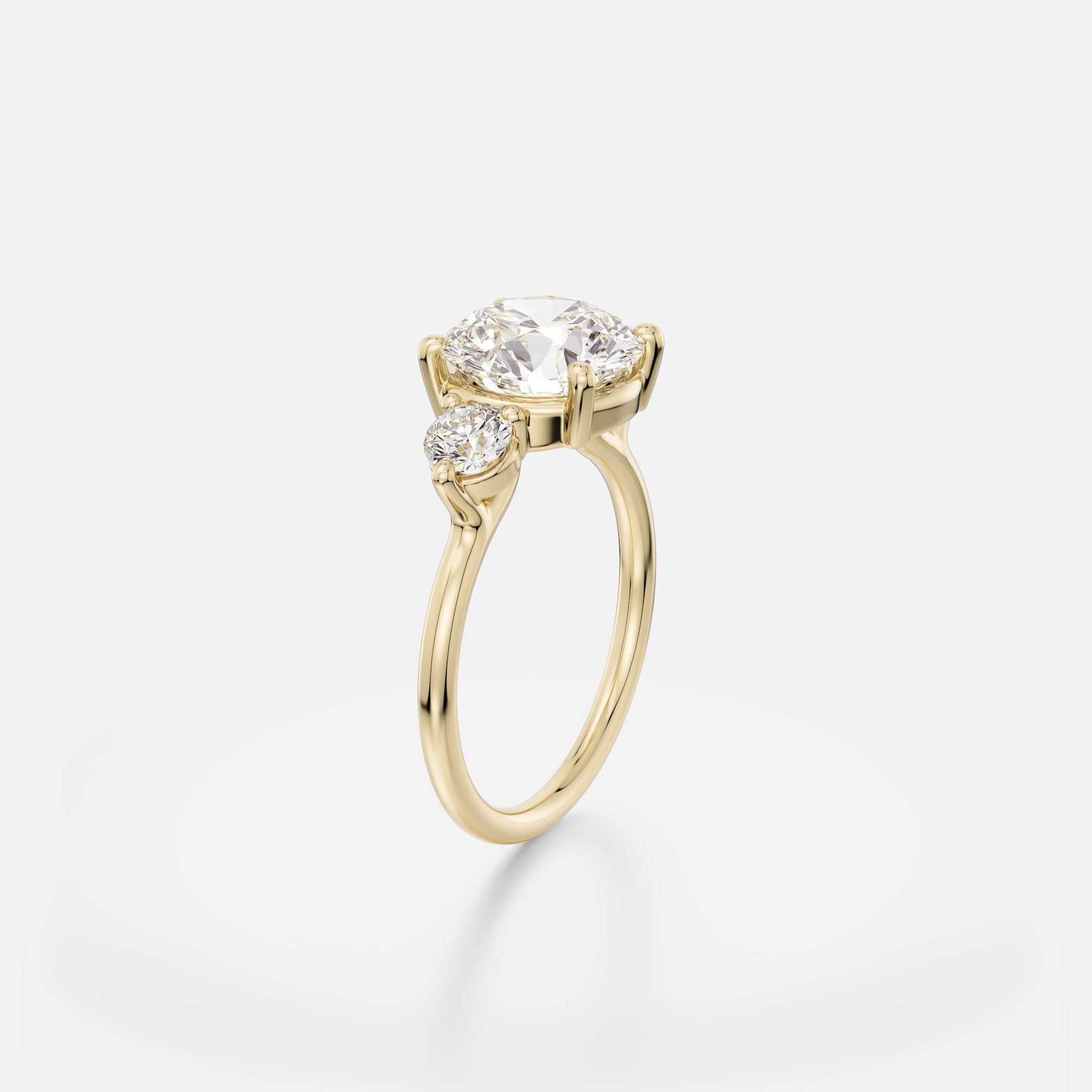 Kala round diamond three stone engagement ring angle view in gold