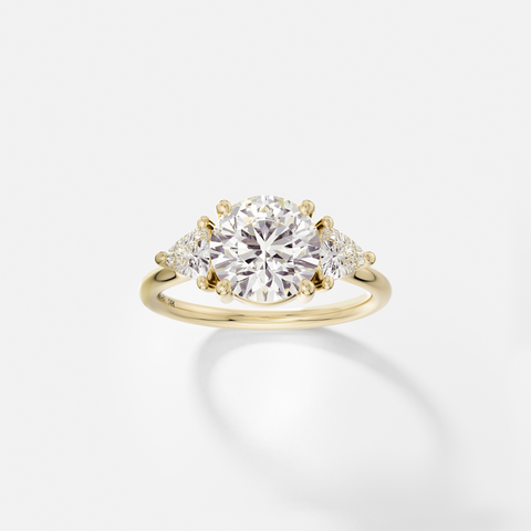 14k yellow gold three stone engagement ring with 2.00 carat round brilliant diamond and trillion-cut side stones in corner prong setting