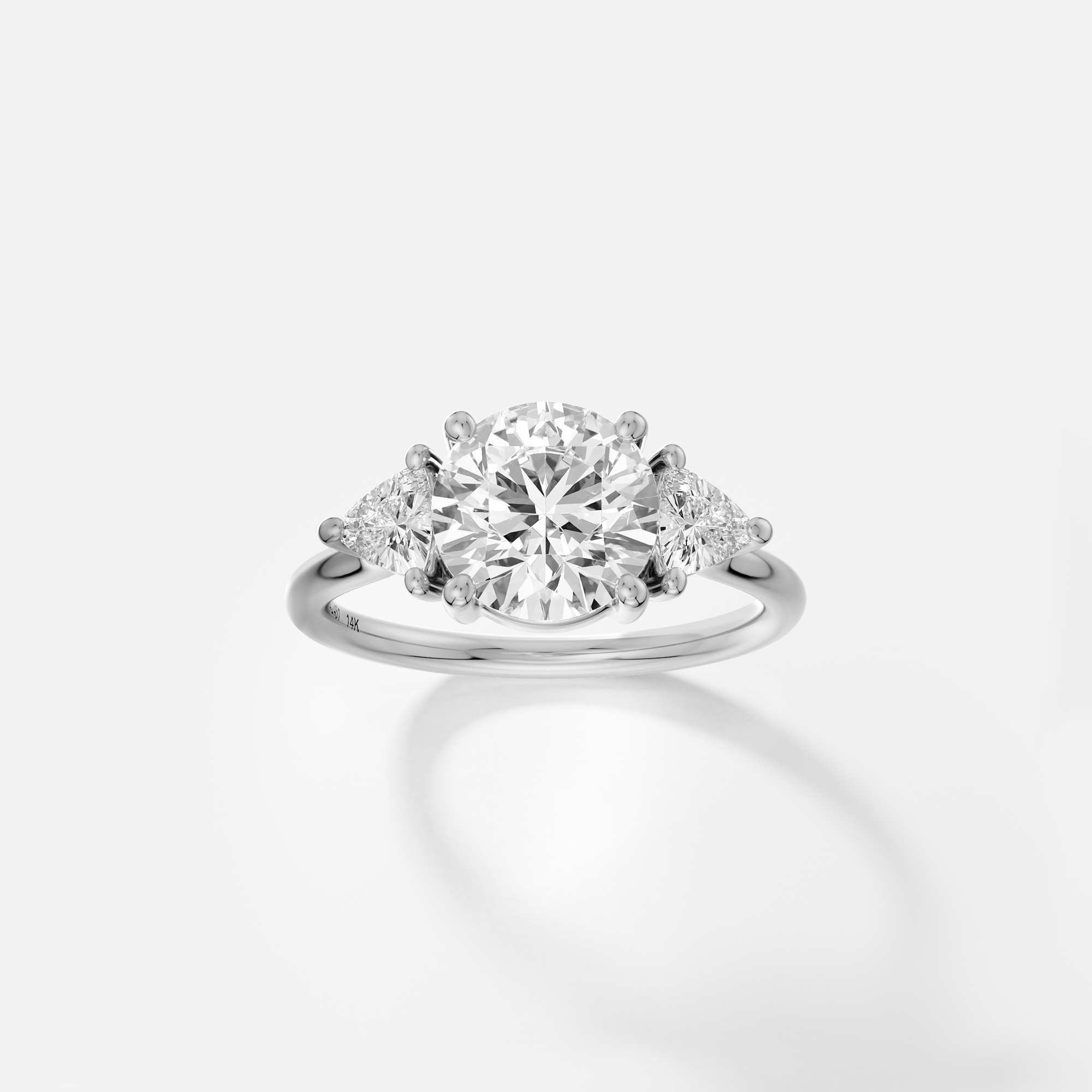platinum engagement ring with 2.00 carat round brilliant diamond and trillion side diamonds on delicate band