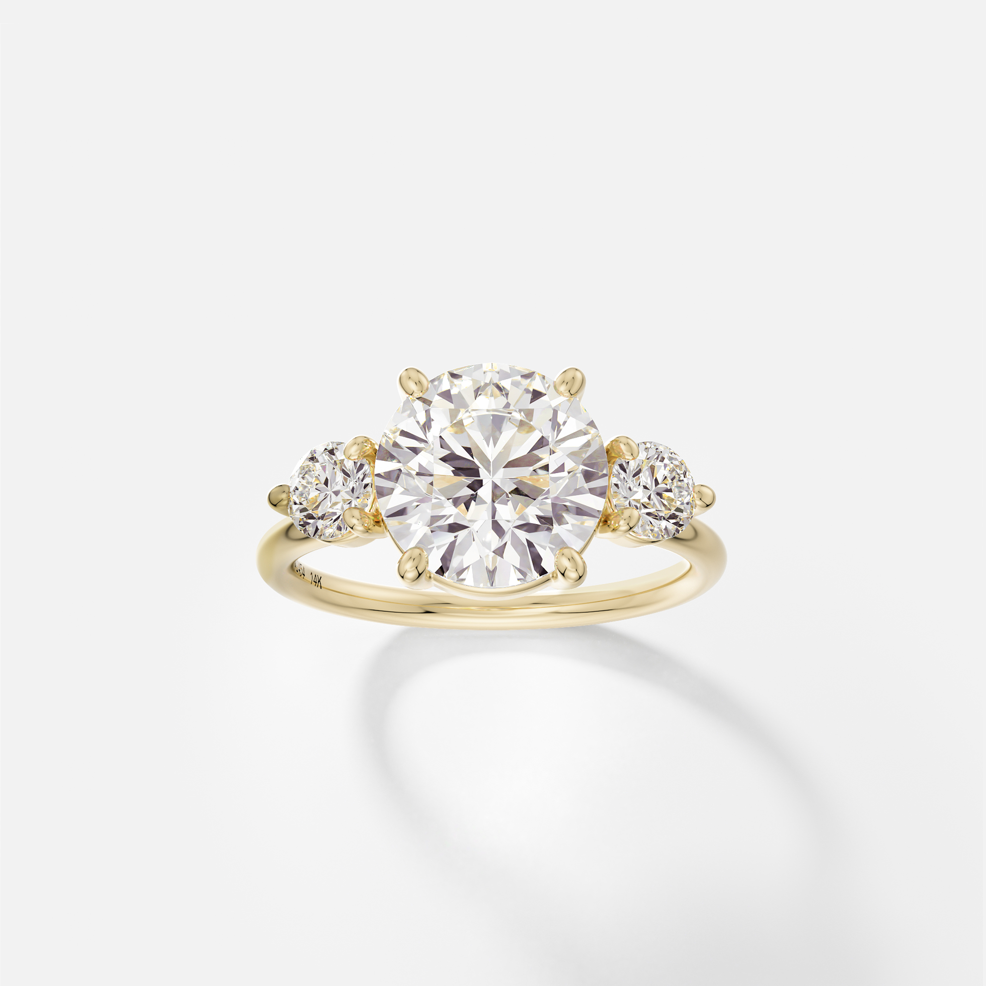 Kala round diamond three stone engagement ring with round side stones front view in 14k yellow gold