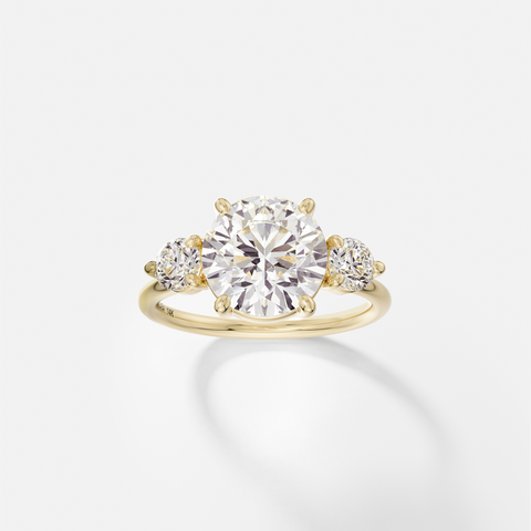 Kala round diamond three stone engagement ring with round side stones front view in 14k yellow gold