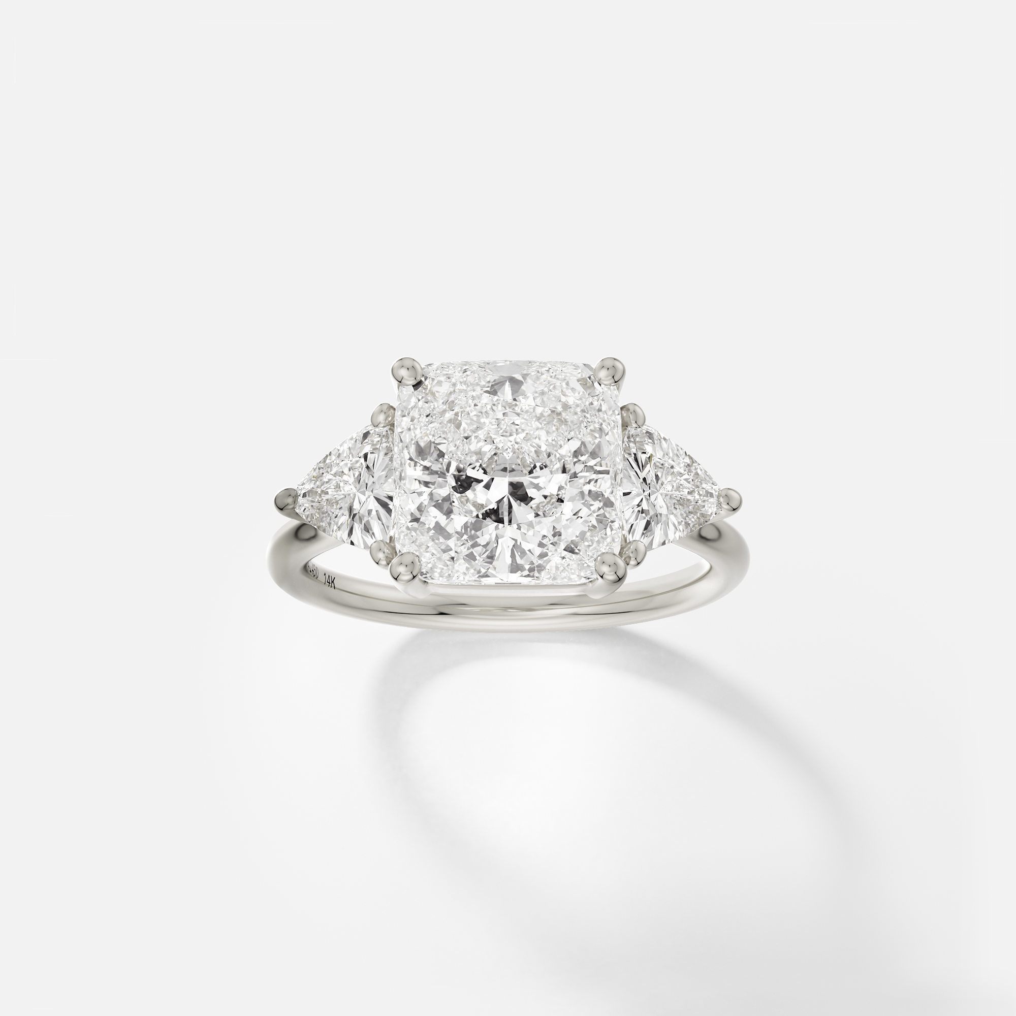 14k white gold engagement ring with 3.50 ct cushion-cut diamond and trillion side stones in prong setting