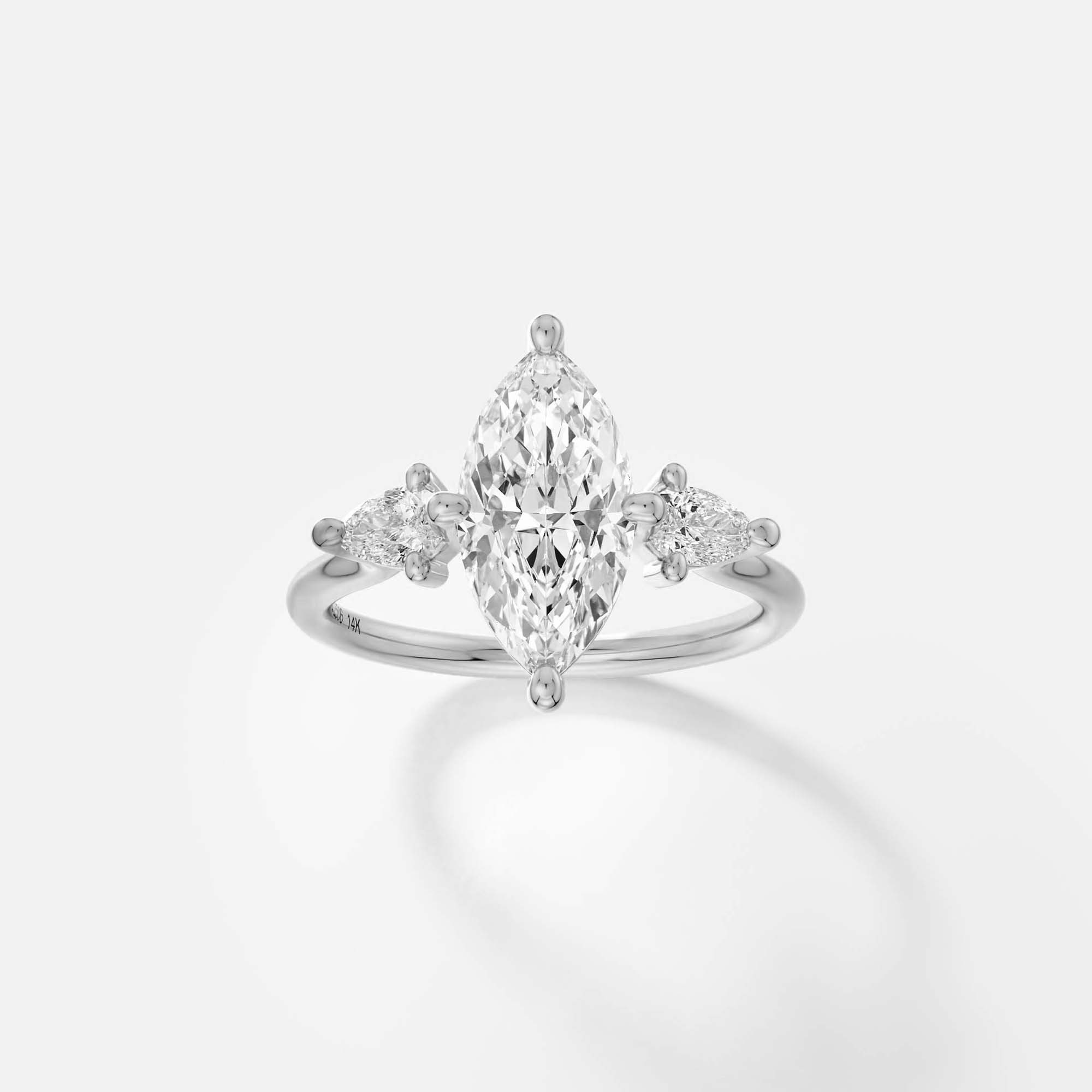 platinum engagement ring with 2.00 carat marquise diamond and pear side stones in compass prong setting on thin round band