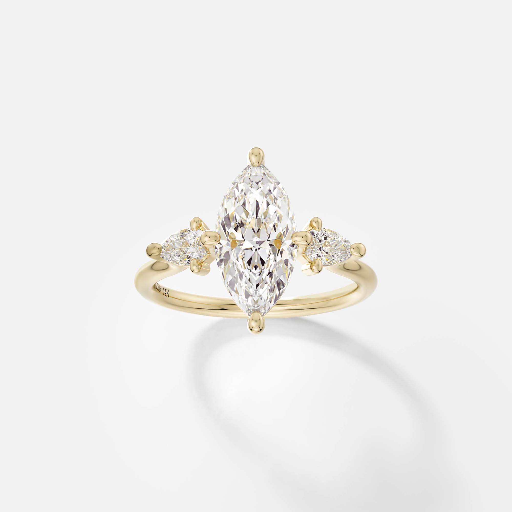 Kele marquise diamond three stone engagement ring with pear side stones front view in 14k yellow gold