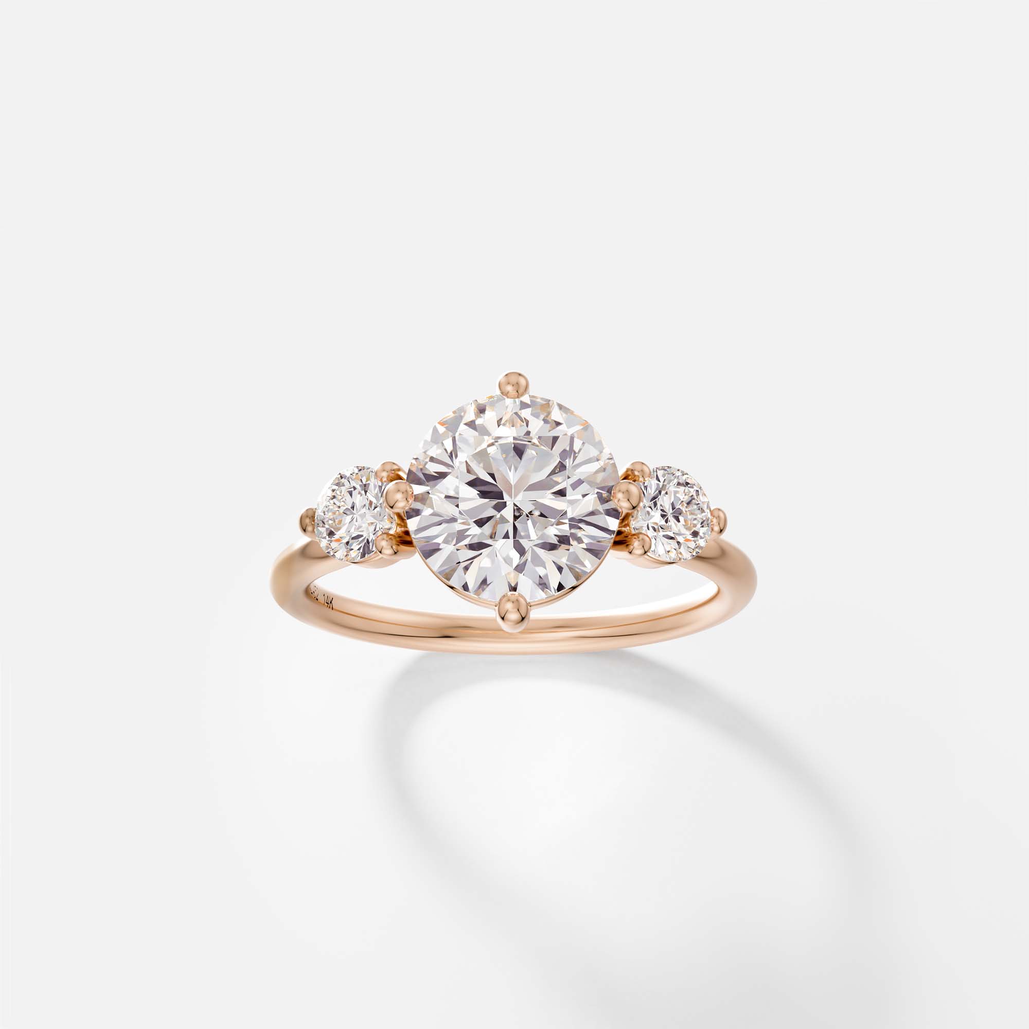14k rose gold engagement ring with 2 carat round brilliant diamond and round side diamonds in prong setting