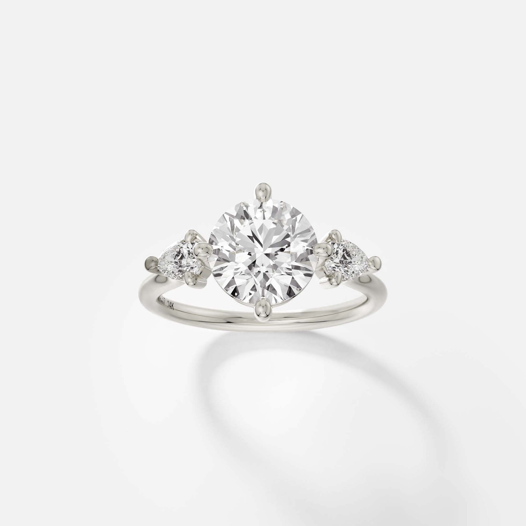 14k white gold engagement ring with 2.00 ct round diamond and pear-cut side stones in compass prong cluster setting