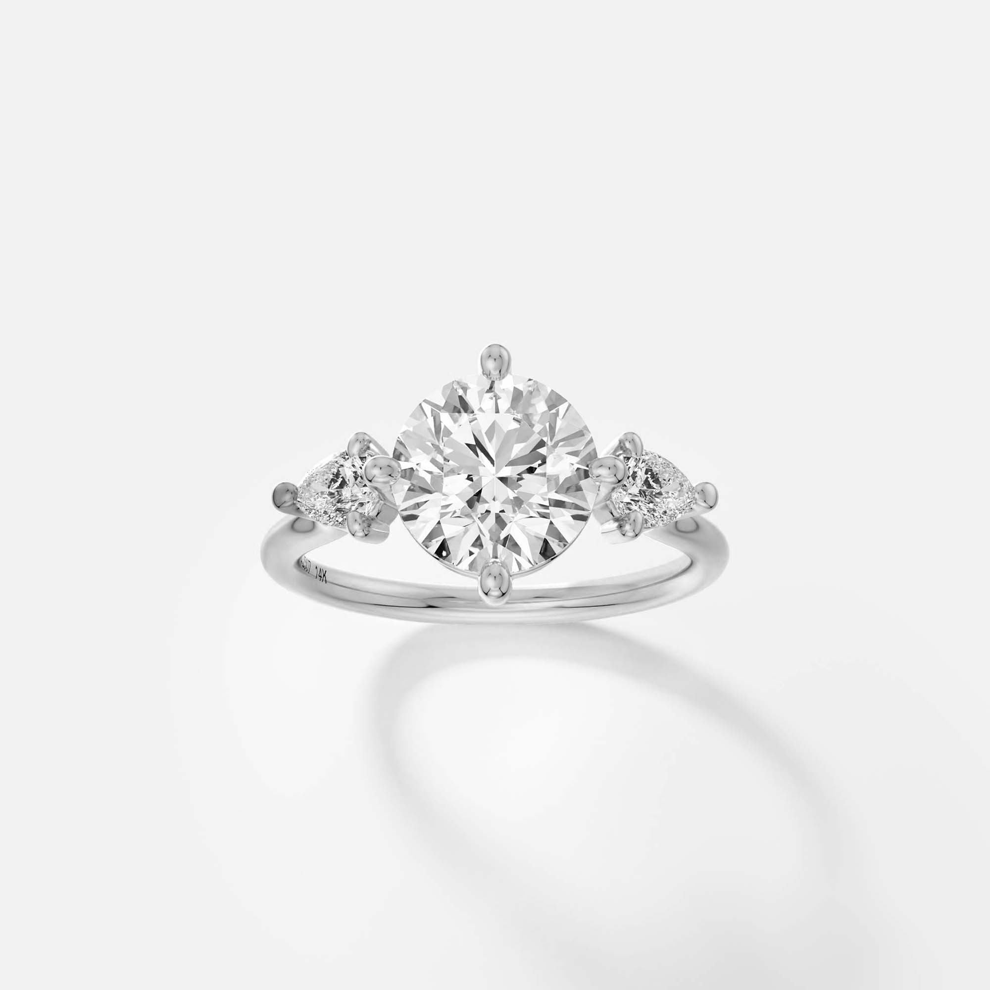 platinum engagement ring with 2.00 carat round brilliant diamond and pear side stones in compass prong setting