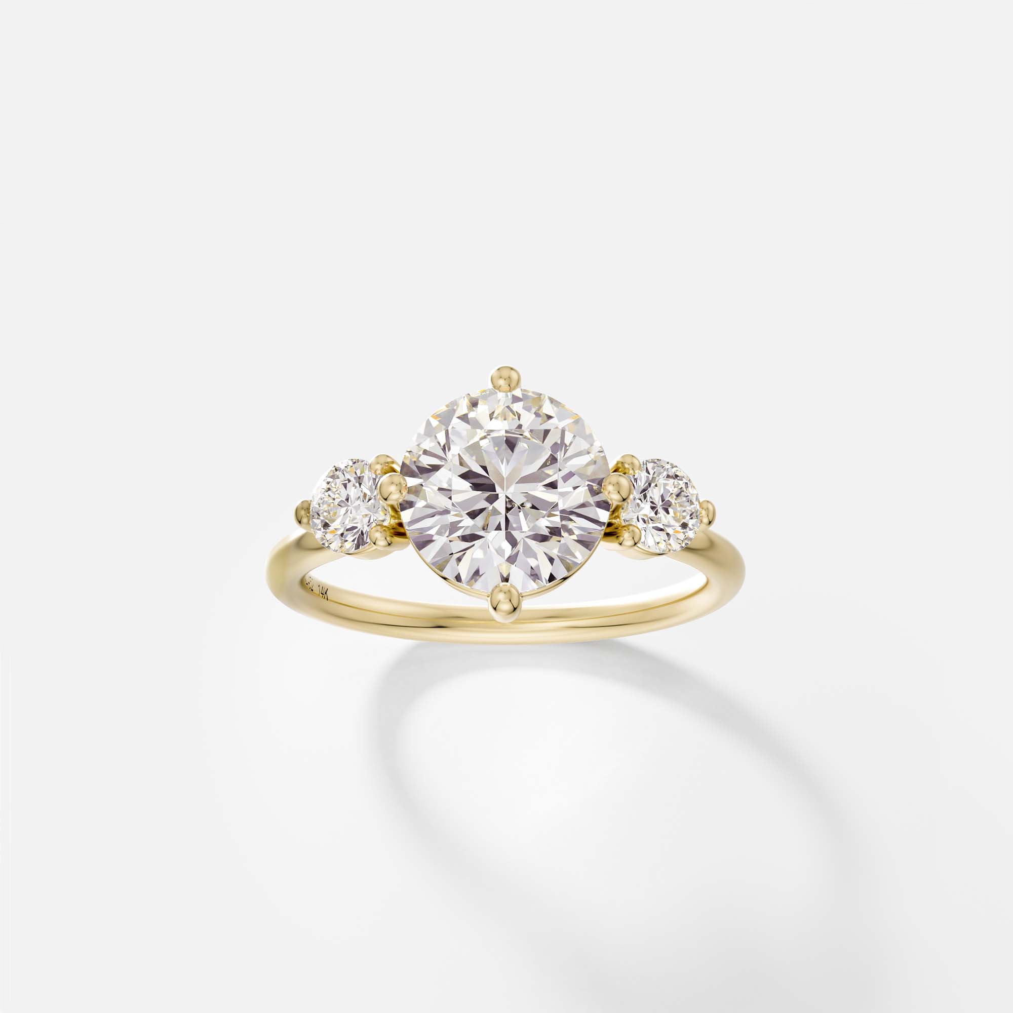 Kele round diamond three stone engagement ring with round side stones front view in 14k yellow gold