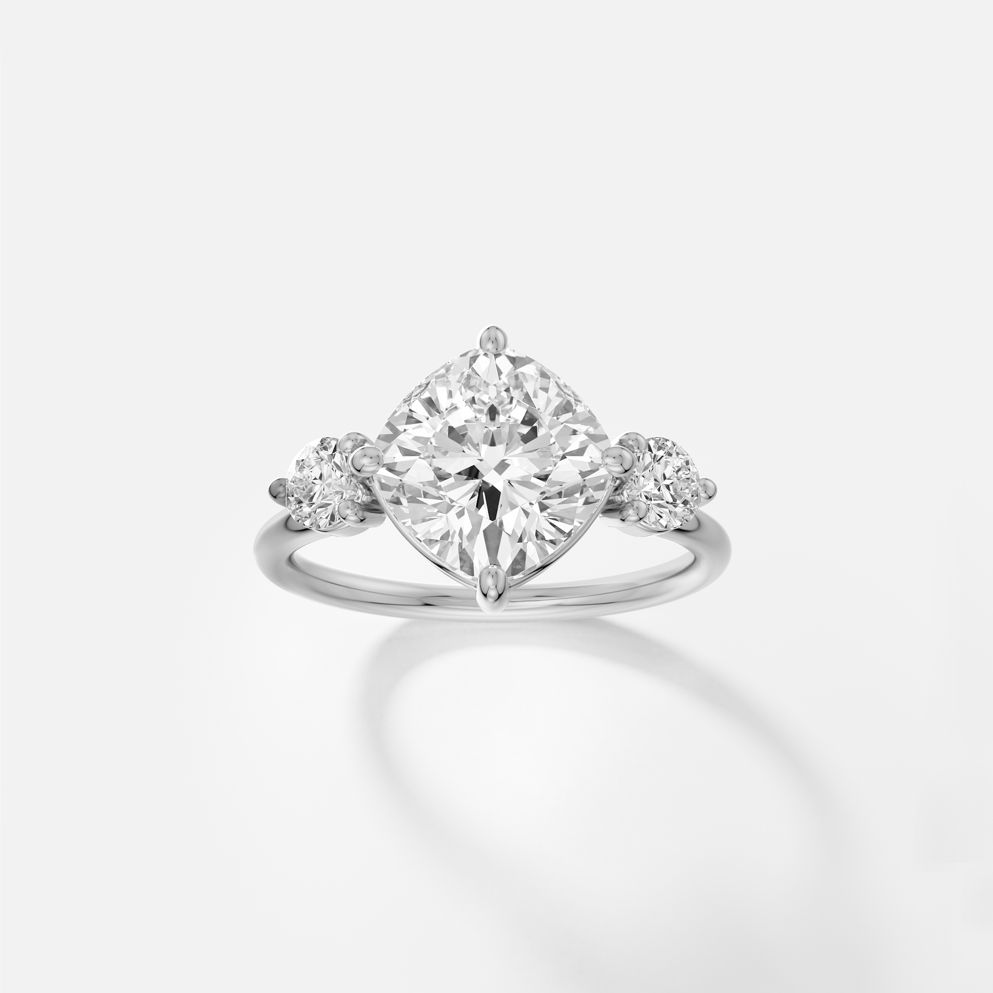Platinum engagement ring with 3.25 carat tilted cushion diamond in compass prong setting on delicate band