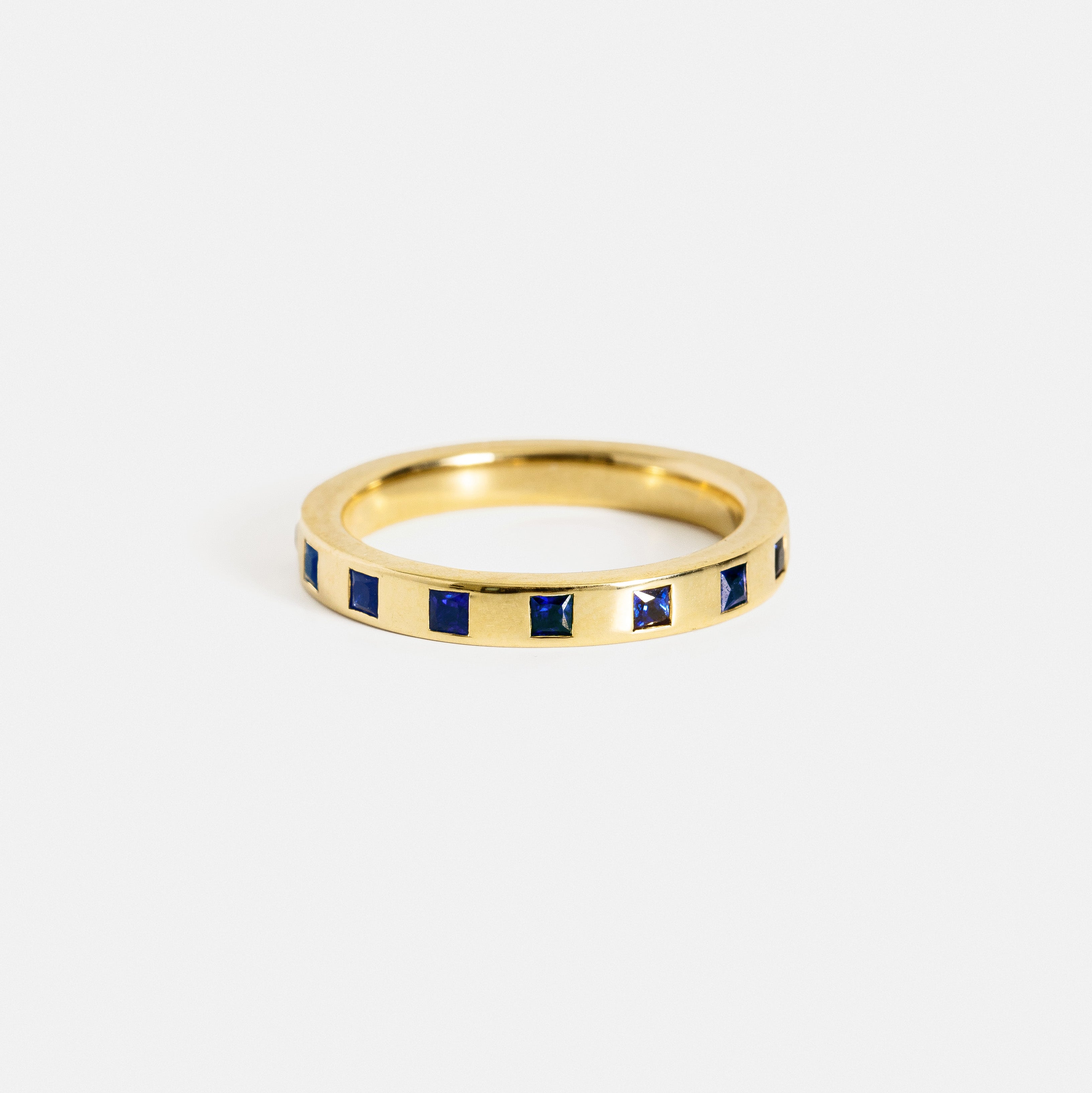 14k yellow gold eternity wedding band with princess-cut sapphires