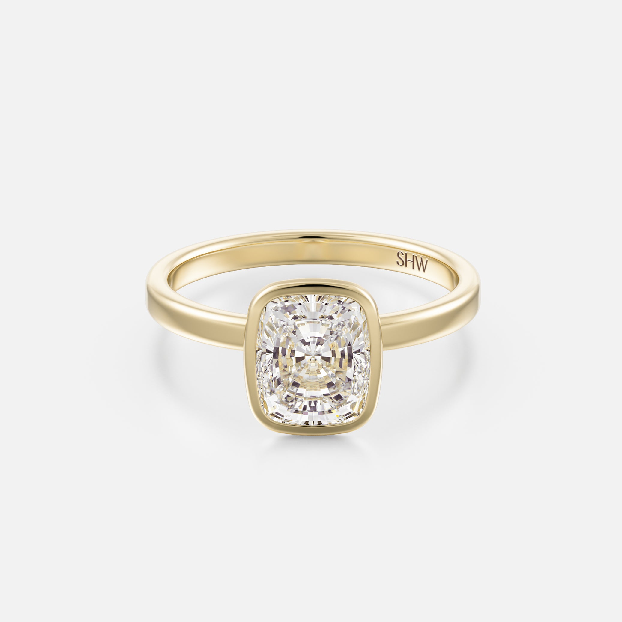 14k yellow gold thin flat band engagement ring with 2ct elongated cushion diamond in bezel setting