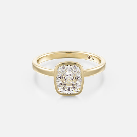 14k yellow gold thin flat band engagement ring with 2ct elongated cushion diamond in bezel setting