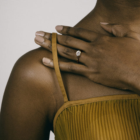 Close view of 1.50 carat oval brilliant-cut diamond set east west in thin bezel