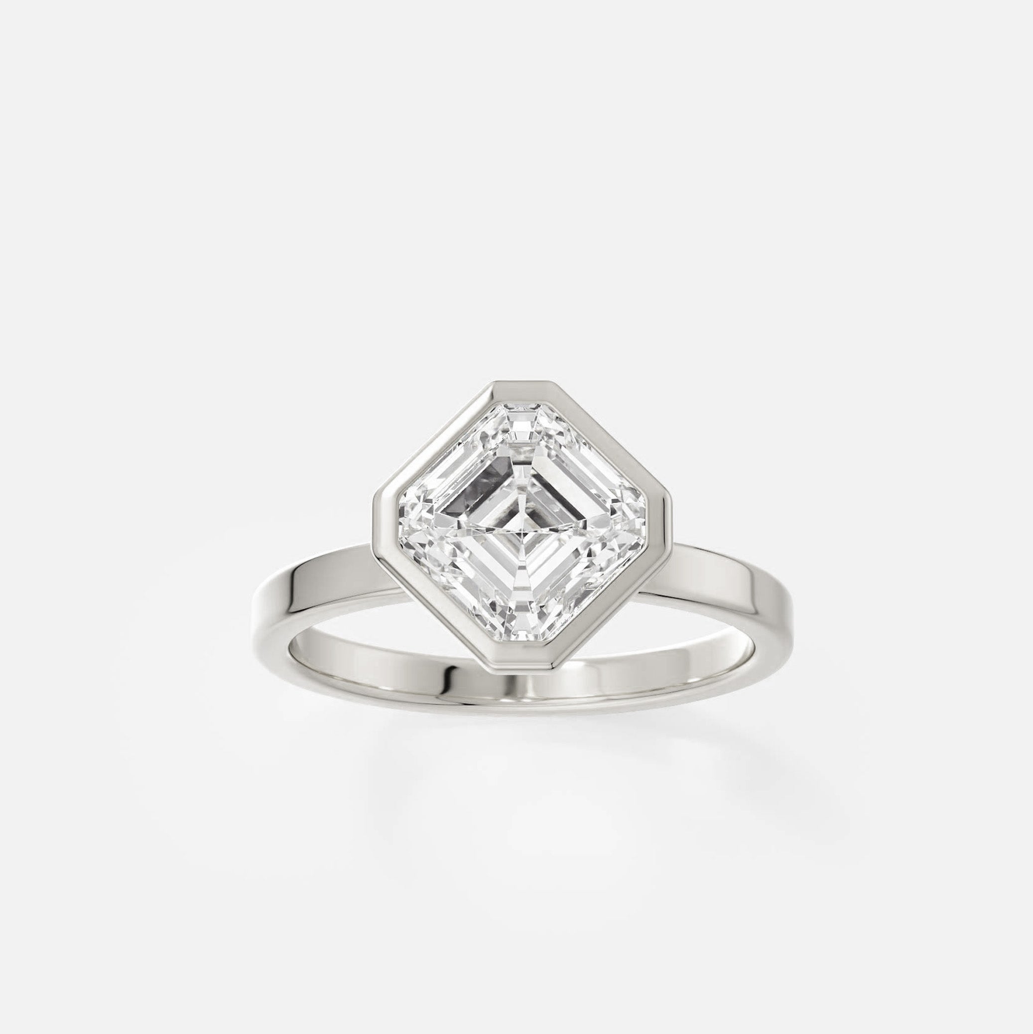 14k white gold engagement ring with tilted asscher-cut diamond in sleek bezel set design on flat profile band