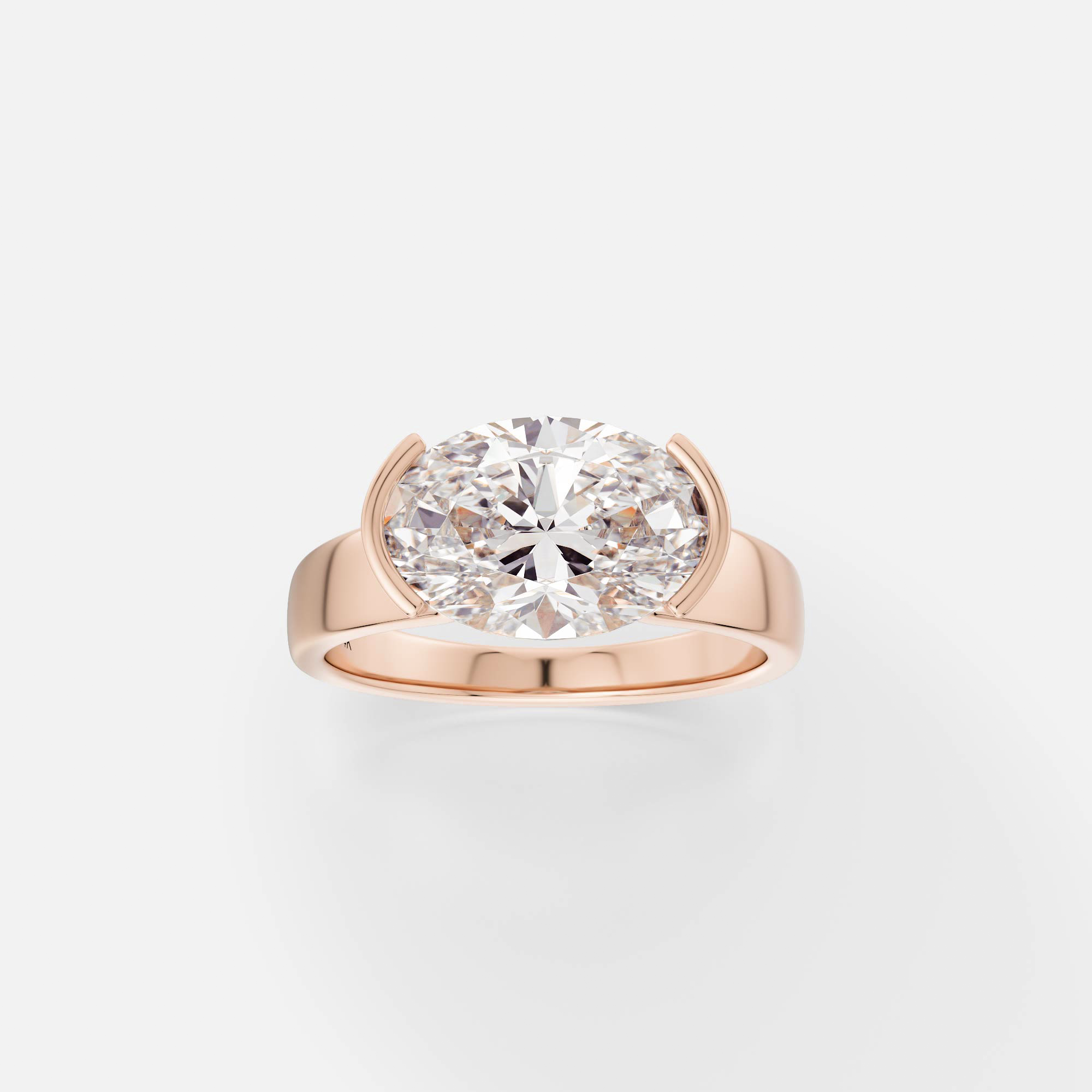 14k rose gold engagement ring with 2.75 carat east-west oval diamond set in tapered partial bezel