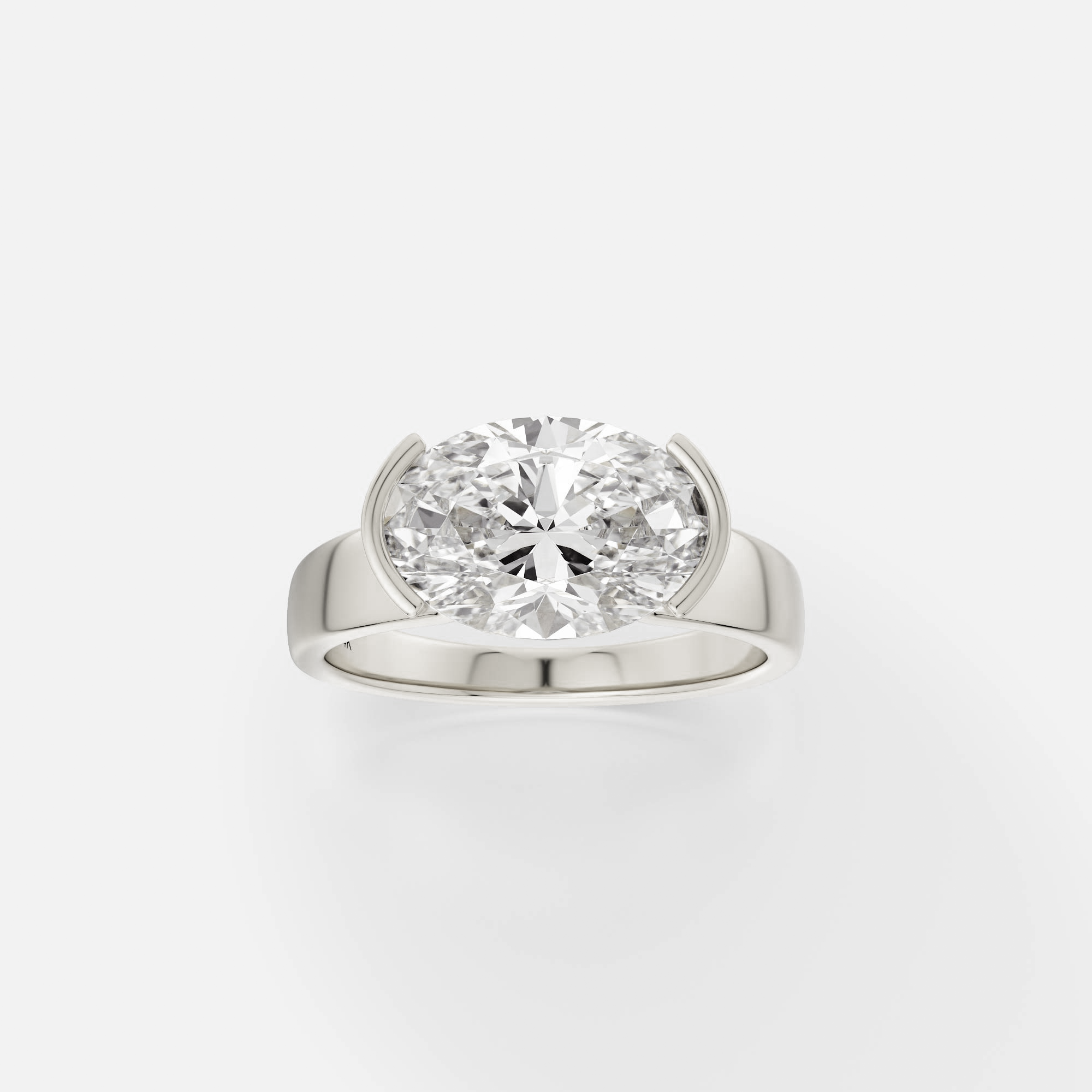14k white gold engagement ring with 2.75 ct east-west oval diamond in tapering partial bezel setting