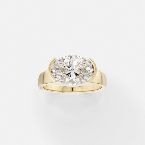14k yellow gold engagement ring with 2.75 carat east-west oval diamond in tapering partial bezel on tapered band