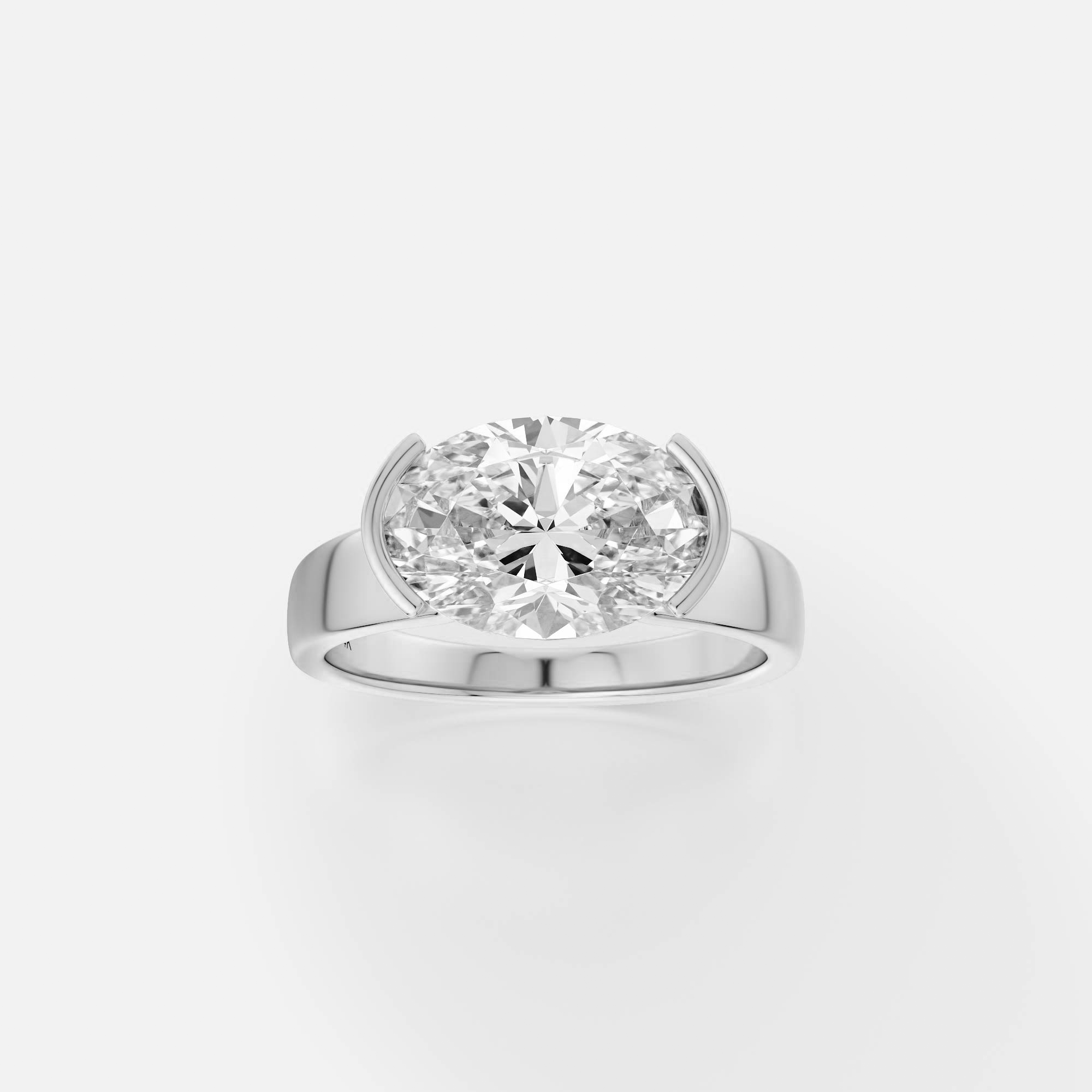 platinum engagement ring with east-west oval diamond in tapered partial bezel on modern band