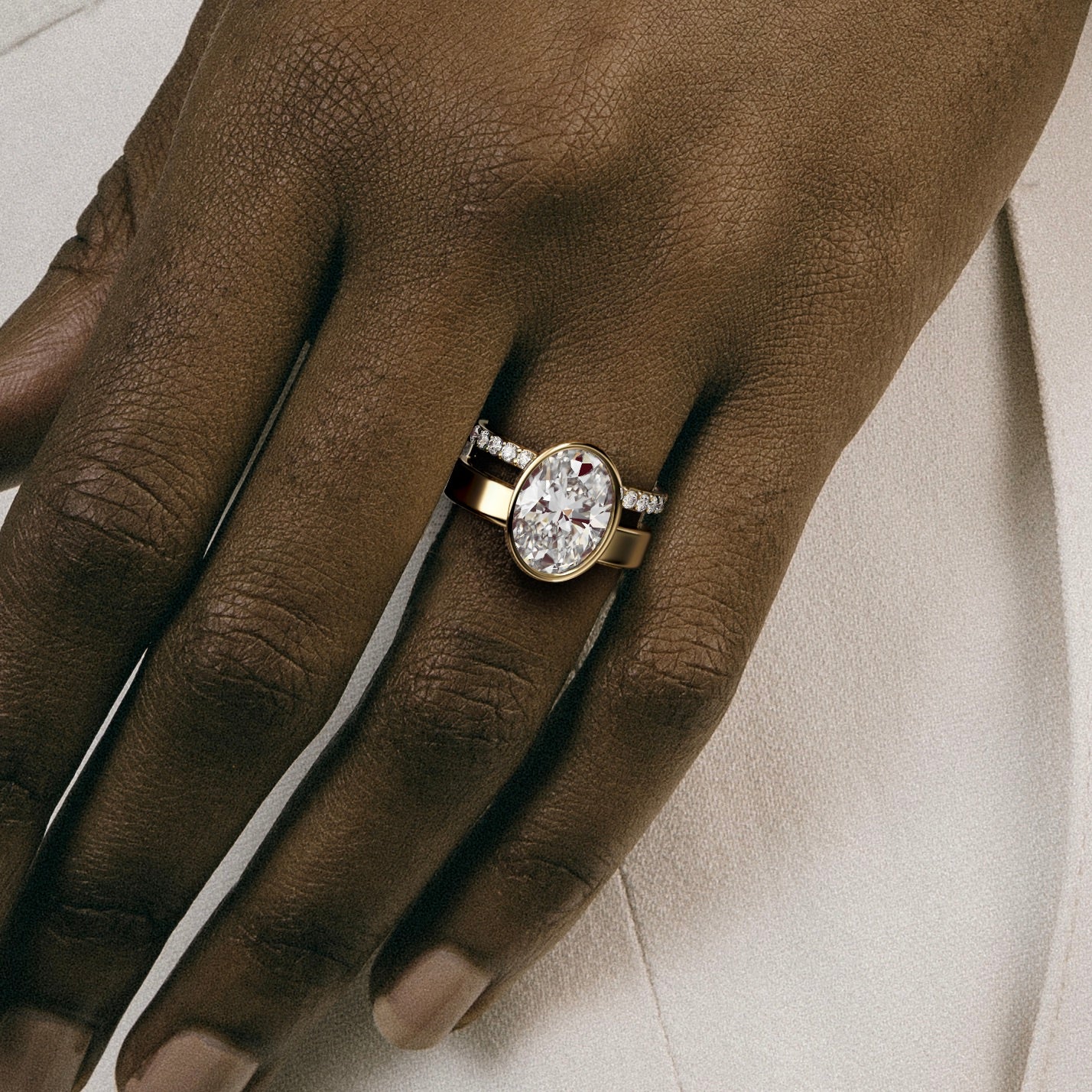close view of 4 ct oval diamond bezel engagement ring with pavé diamond eternity band on double band