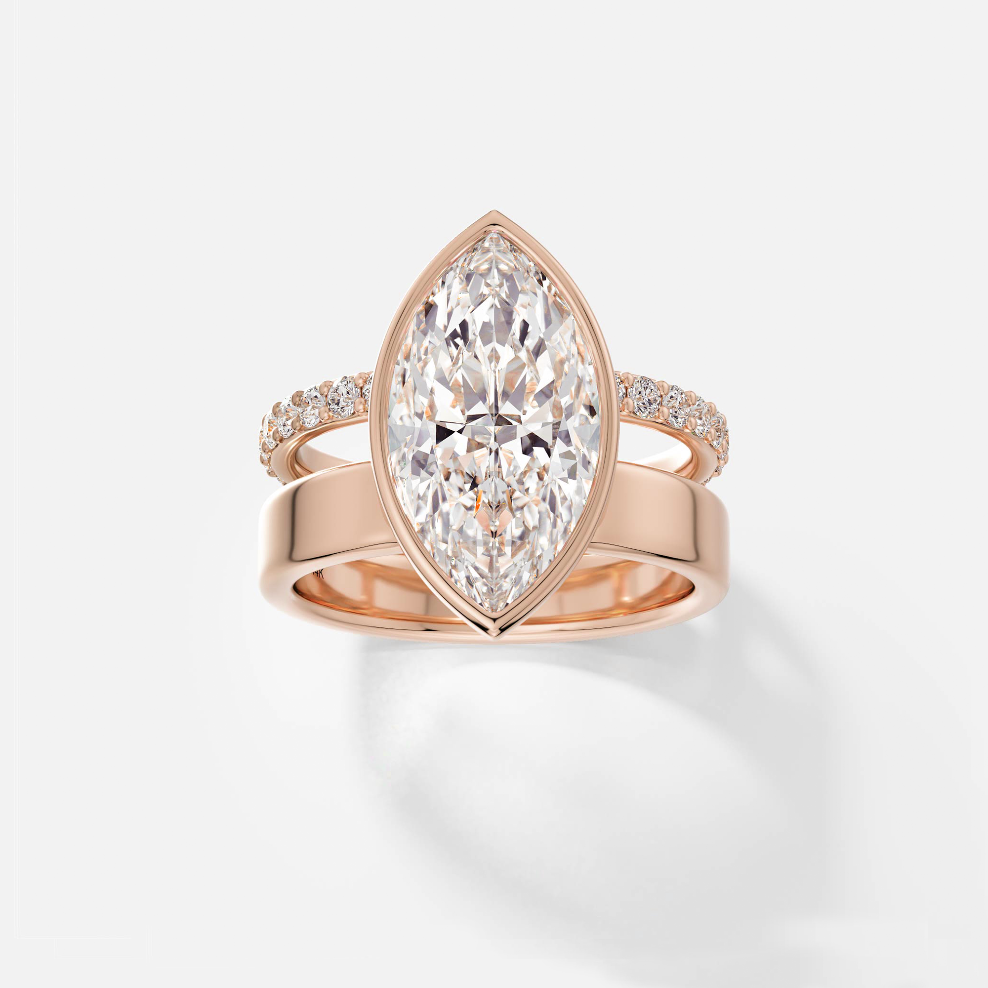 14k rose gold engagement ring with 4 carat marquise-cut diamond in bezel setting and pavé diamond eternity band