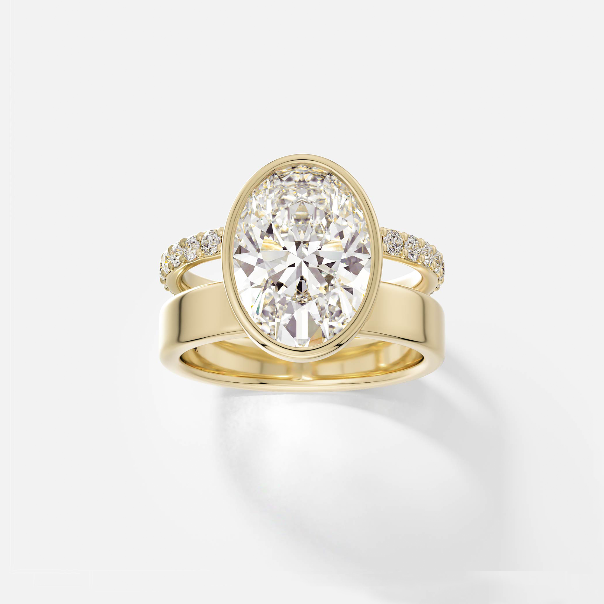 14k yellow gold engagement ring with 4.00 carat oval diamond set north-south in bezel setting with pavé diamond eternity band