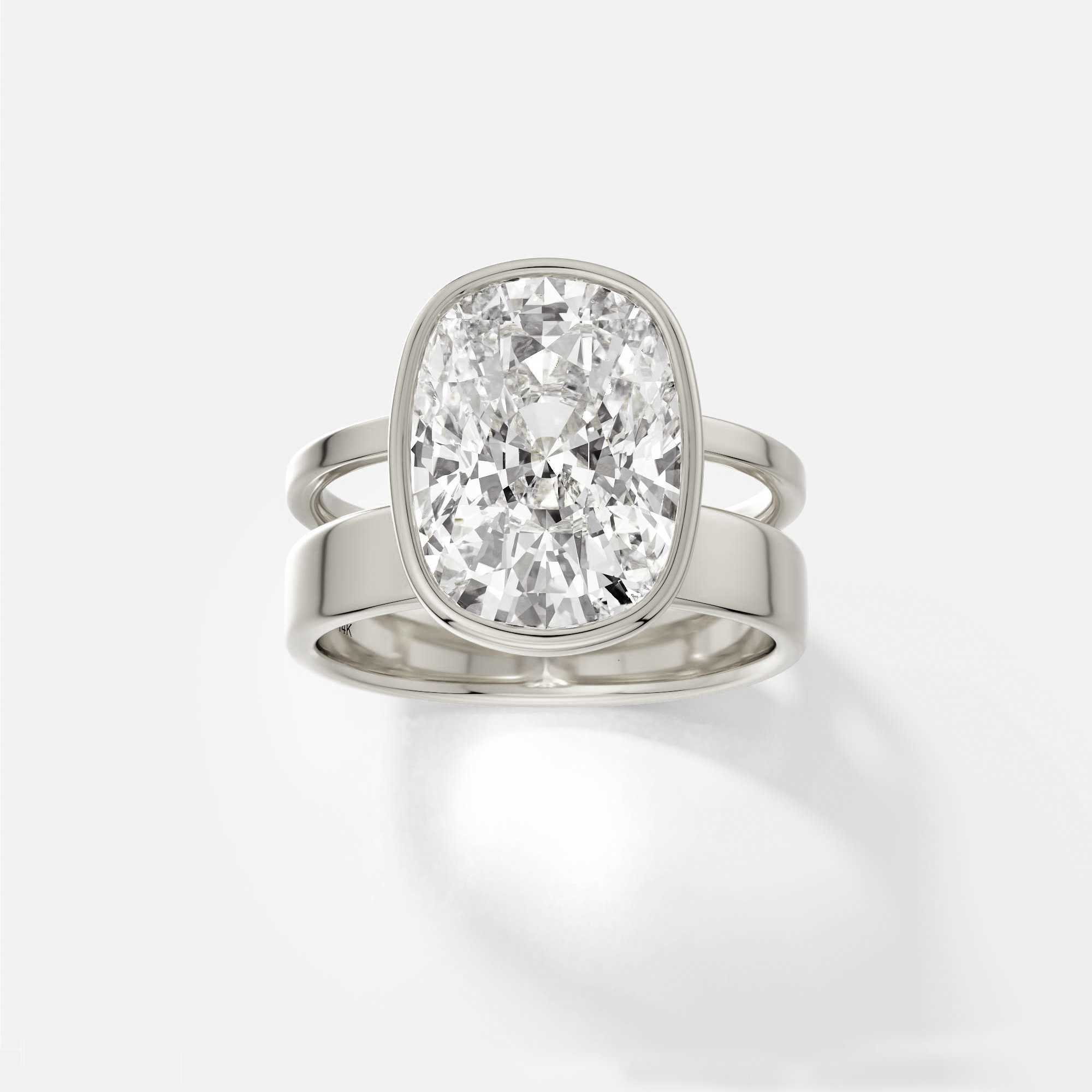 14k white gold engagement ring with 4.00 ct cushion diamond in bezel setting on sculptural double band