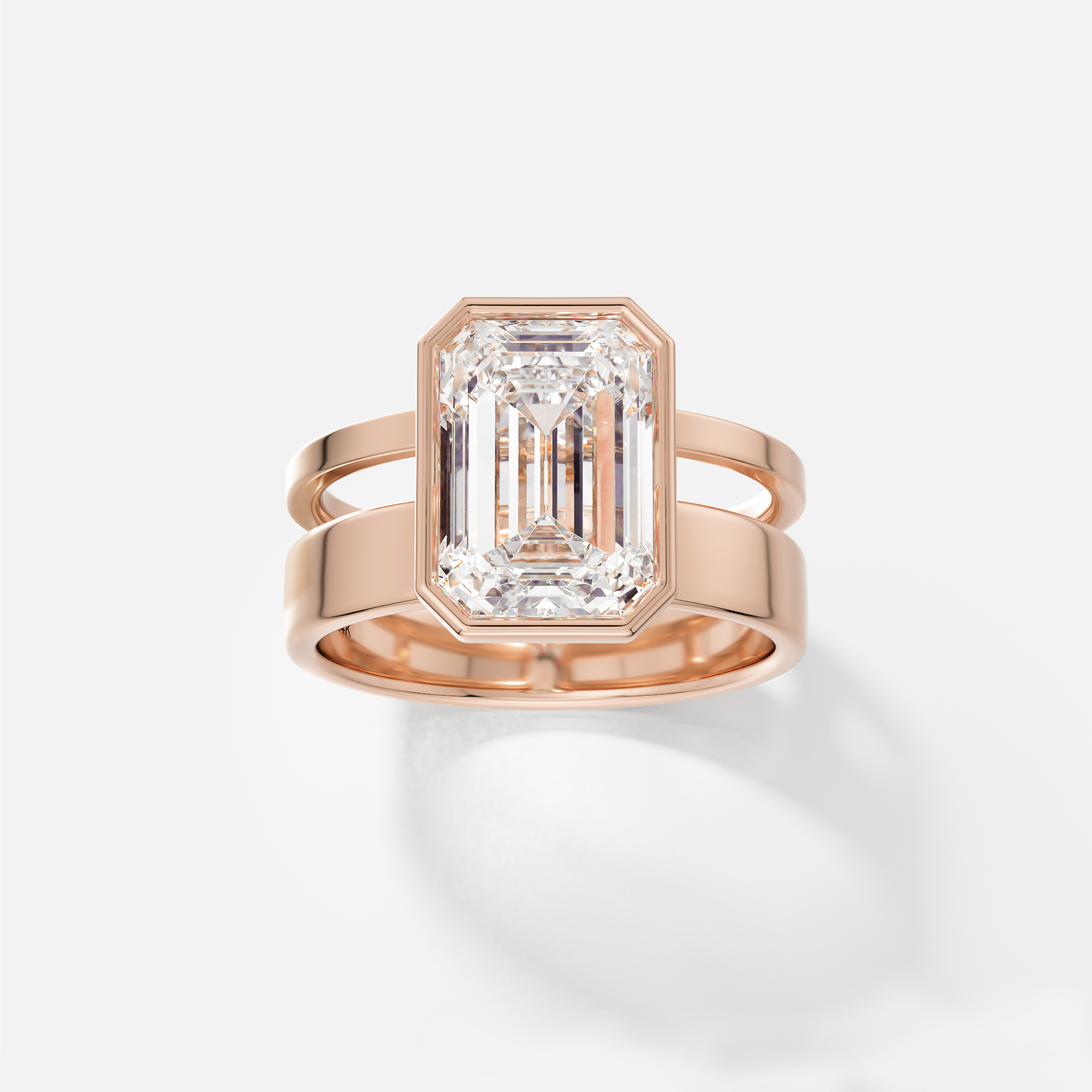 14k rose gold engagement ring with 4 carat emerald cut diamond bezel set on sculptural double band