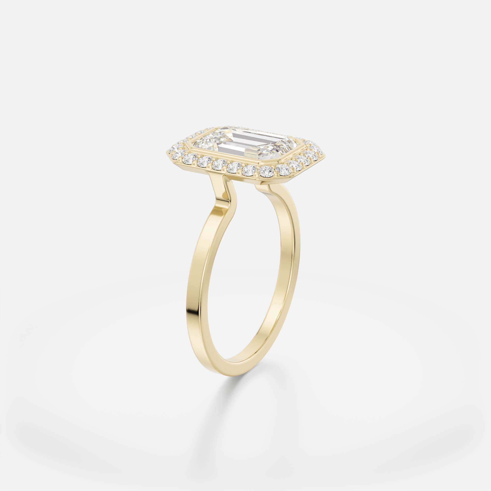 Thin flat band engagement ring with emerald-cut step-cut diamond surrounded by pavé halo