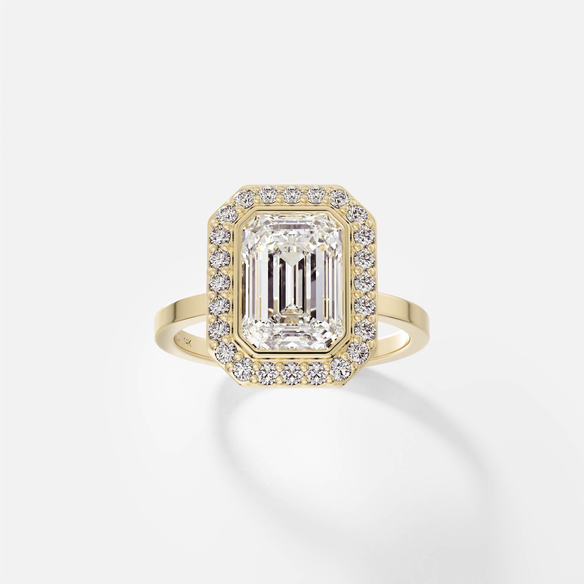 14k yellow gold halo engagement ring with 2.50 carat emerald-cut diamond in bezel halo with pavé diamond surround