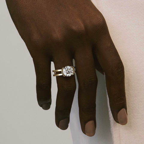 close view of round brilliant 2.50ct diamond engagement ring with sculptural double band and open bezel